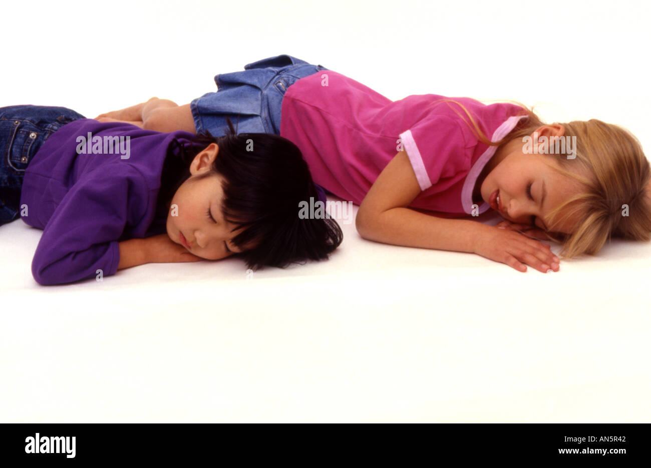 Two Girls Sleeping On Floor Stock Photo 5034817 Alamy