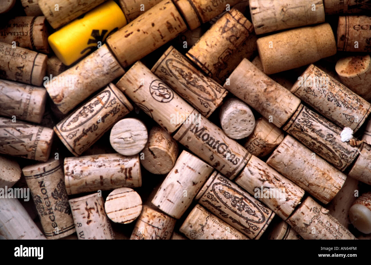 Corks Stacked up in a shop window. One yellow plastic cork stands out