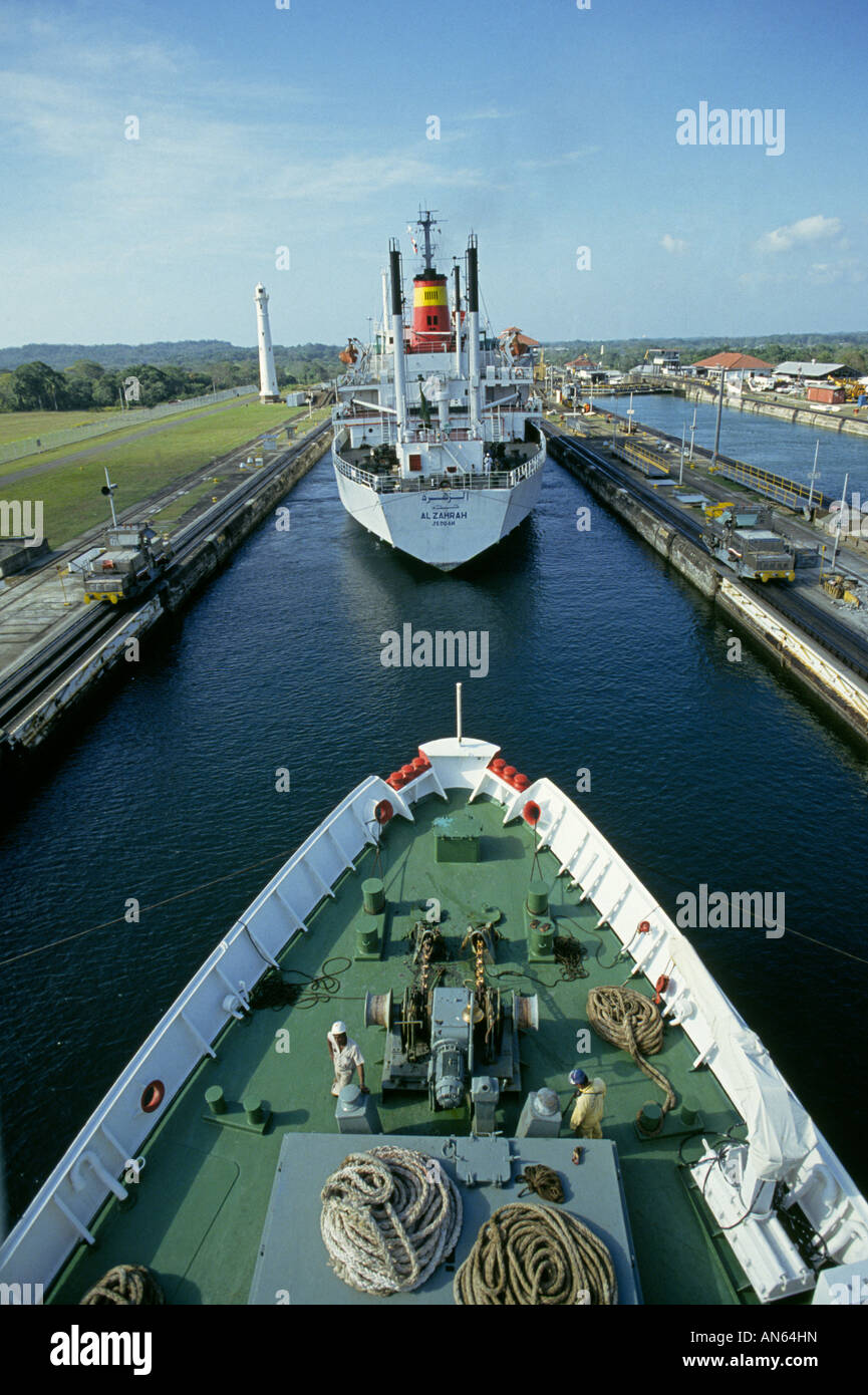 A cargo ship and a passenger ship make a daylight passage through the
