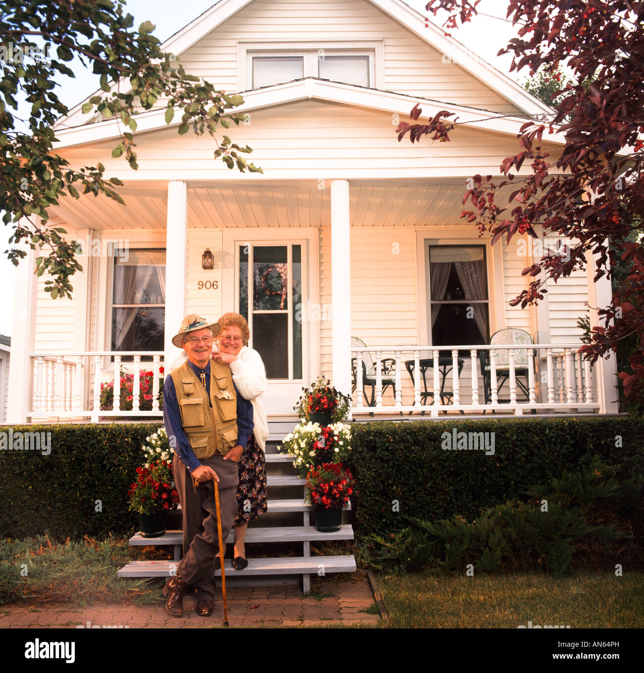 Elderly couple in front of their house Stock Photo - Alamy