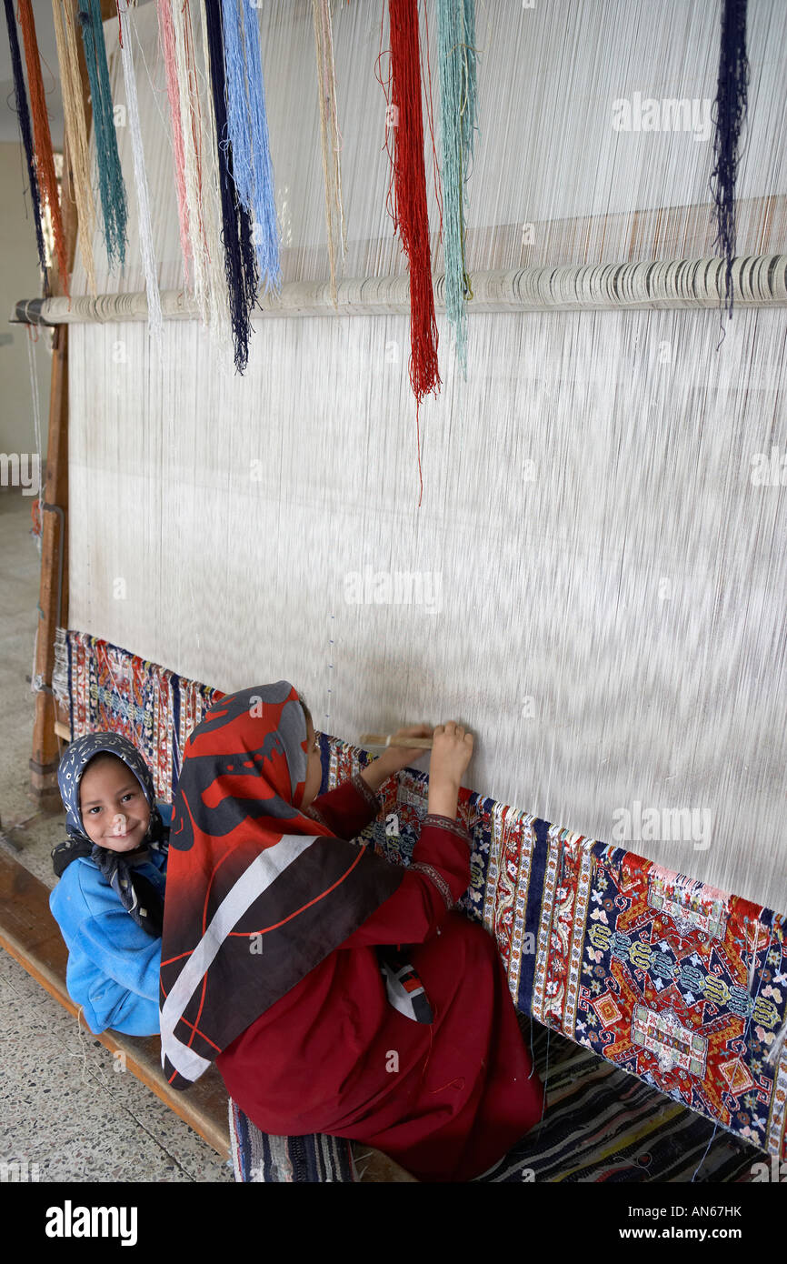 Children weaving carpets in carpet factory near Cairo Egypt Stock Photo
