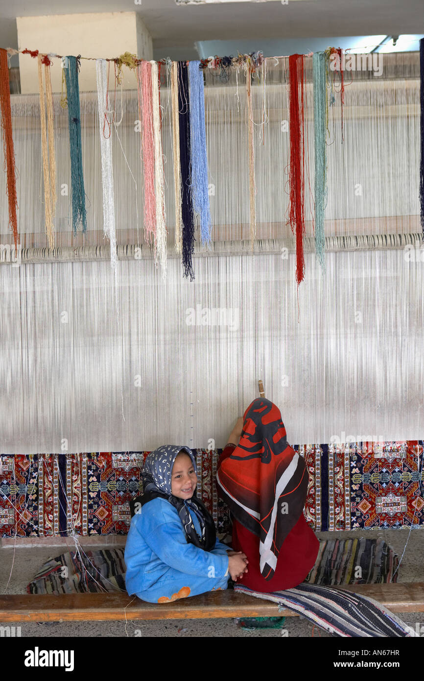Children weaving carpets in carpet factory near Cairo Egypt Stock Photo