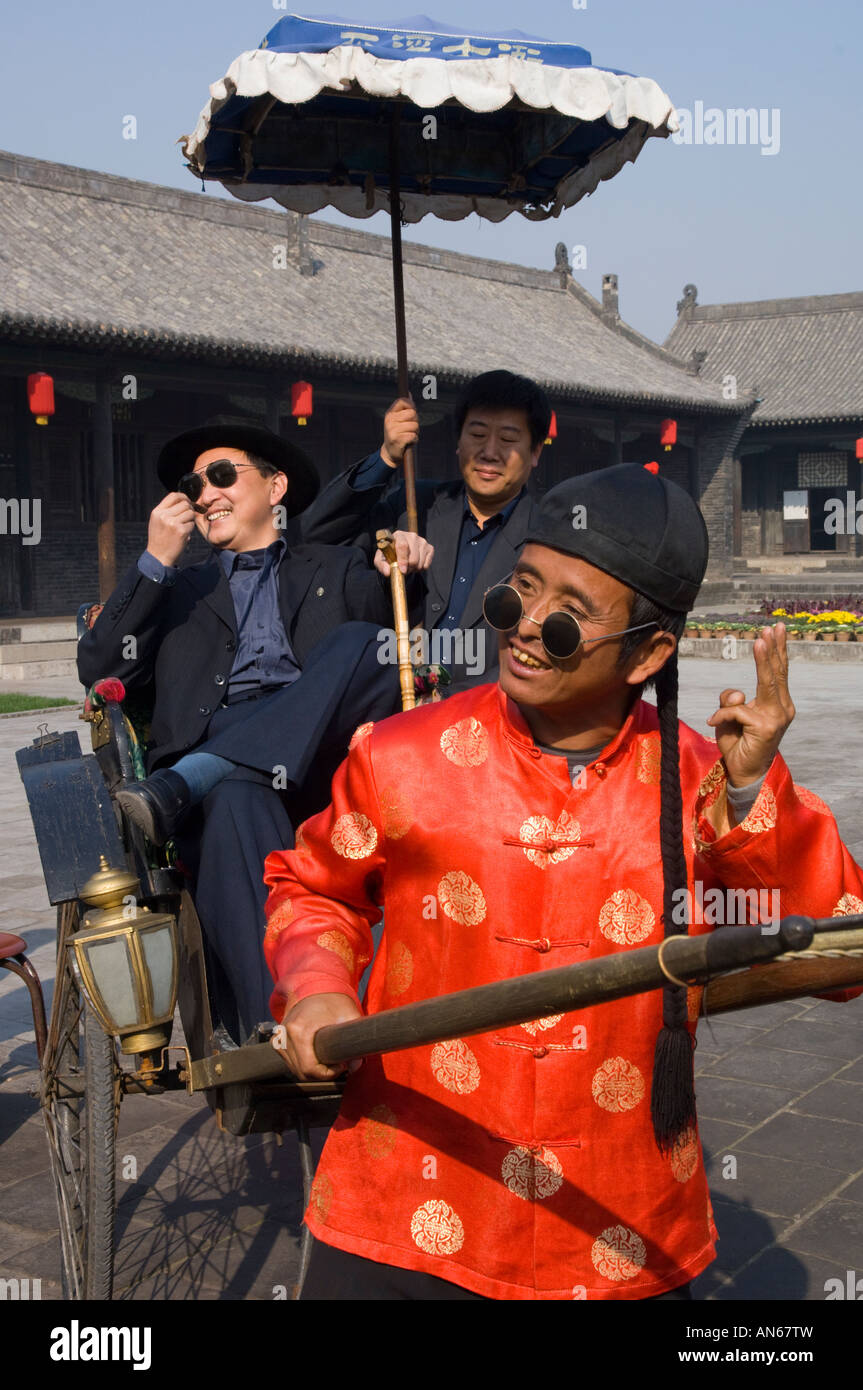 China Shanxi Pingyao rickshaw driver pausing for camera Stock Photo - Alamy