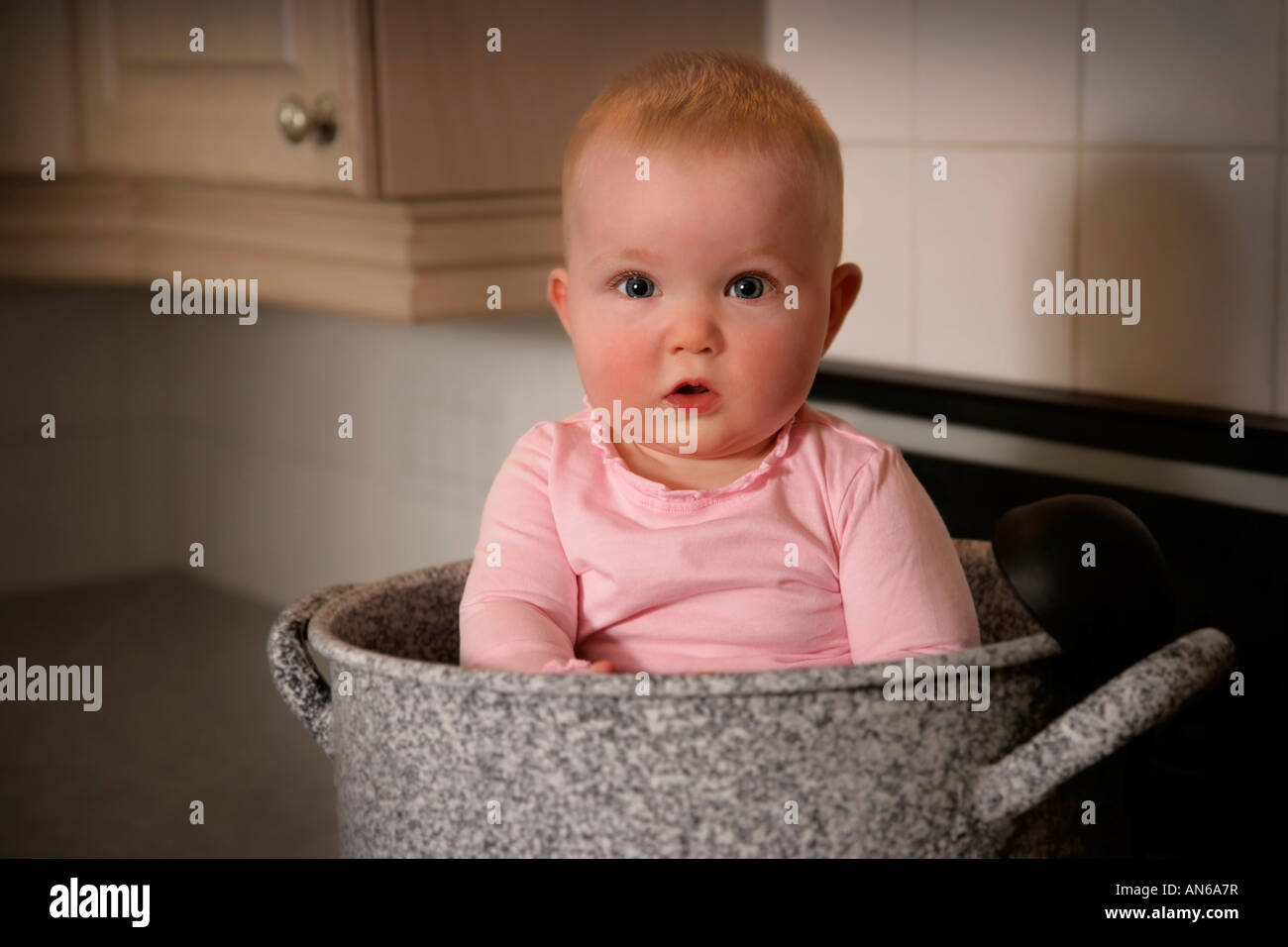 Baby in a large pot Stock Photo Alamy