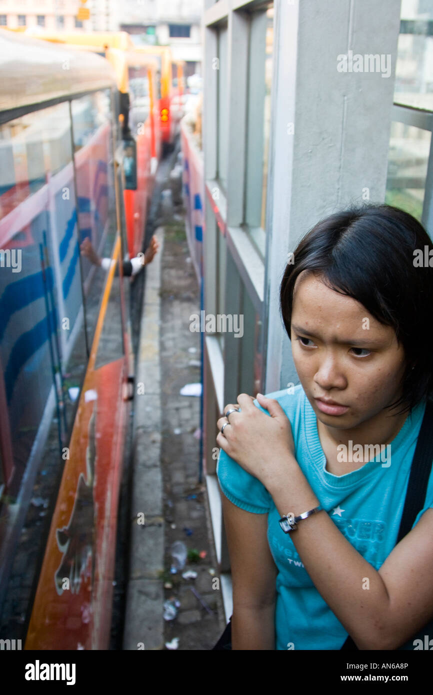 Young Woman Waiting on a Bus Platform Trans Jakarta Busway Rapid Transit System Jakarta Indonesia Stock Photo