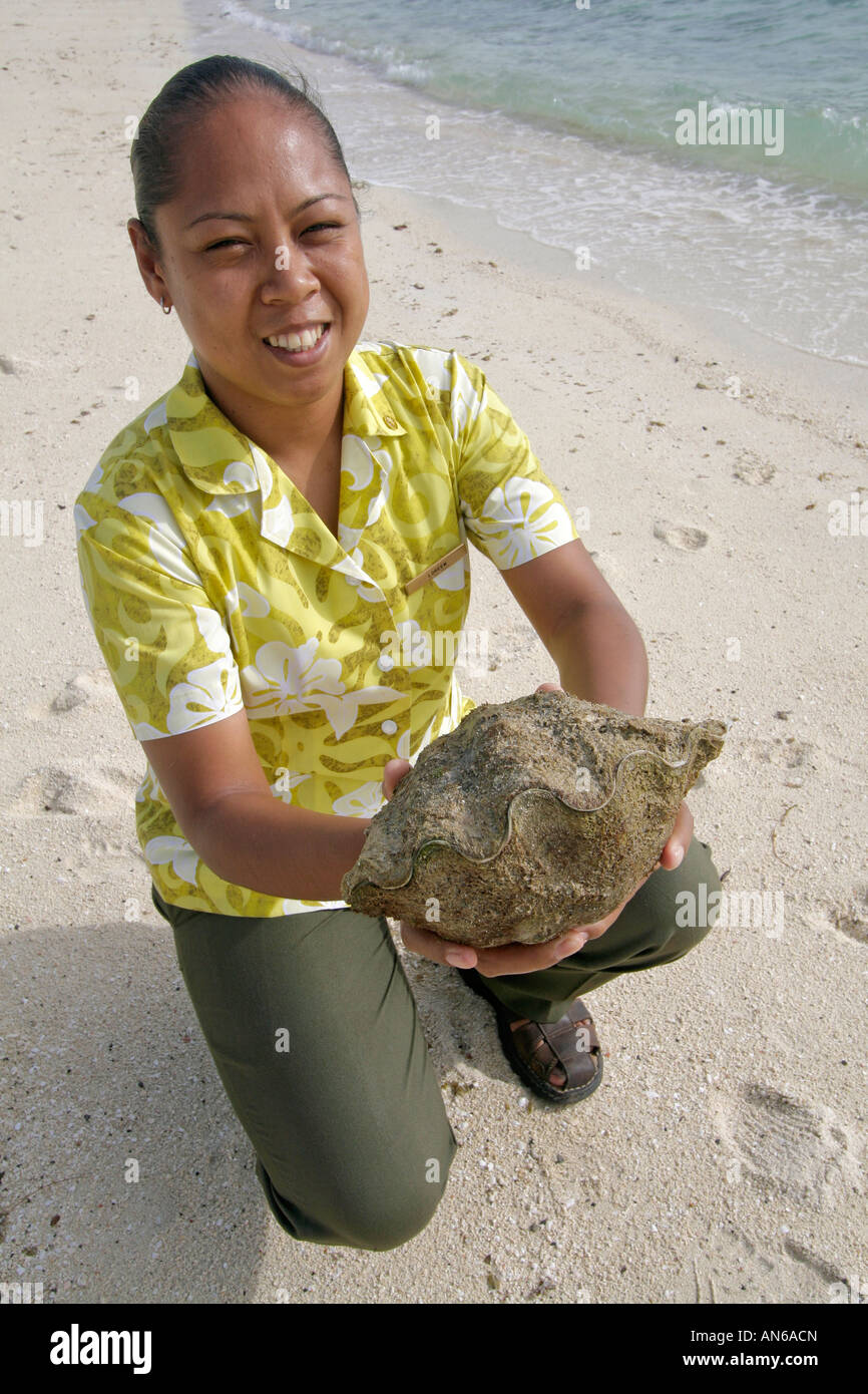 Palau woman holds baby giant clam Stock Photo