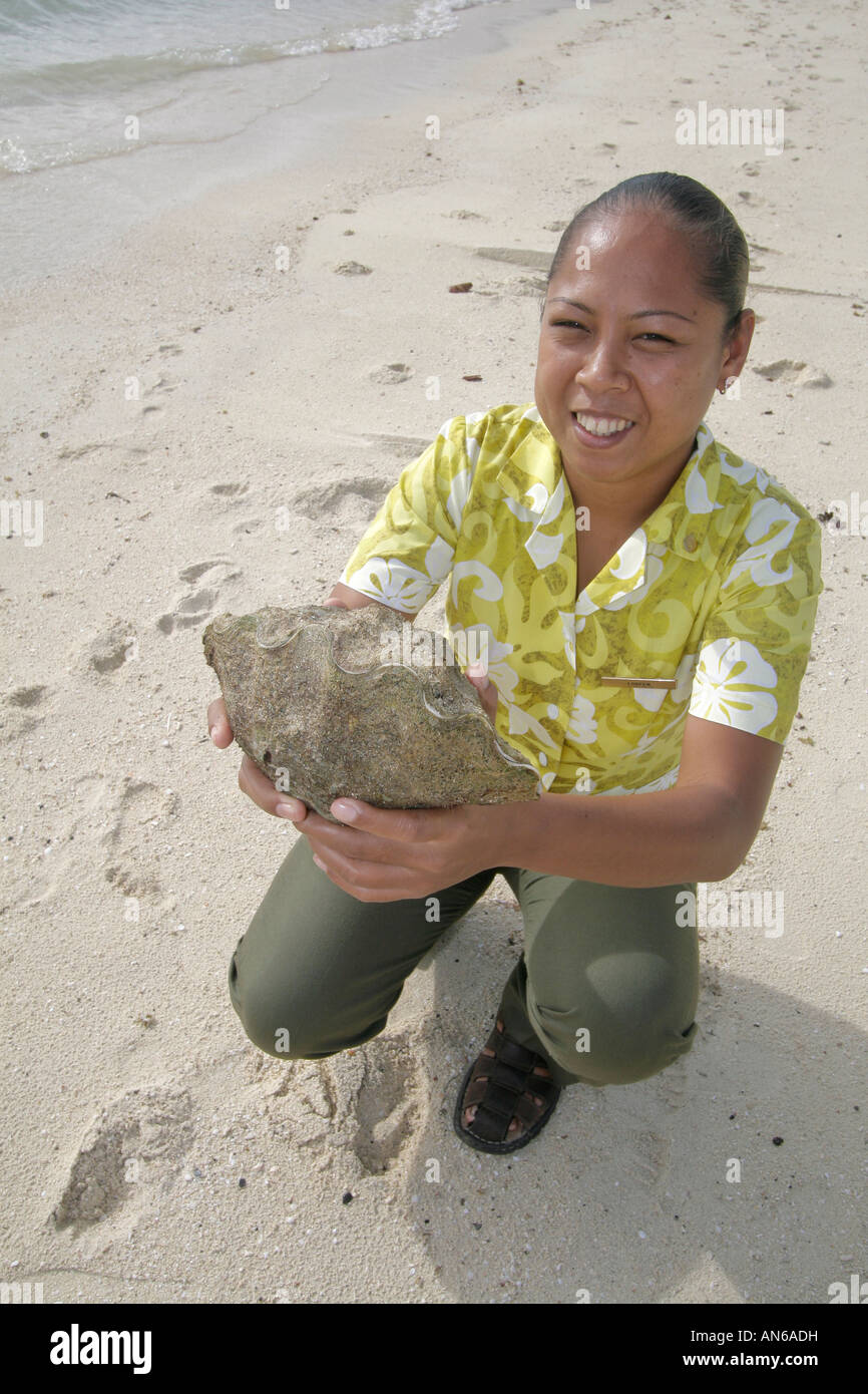 Palau woman holds baby giant clam Stock Photo