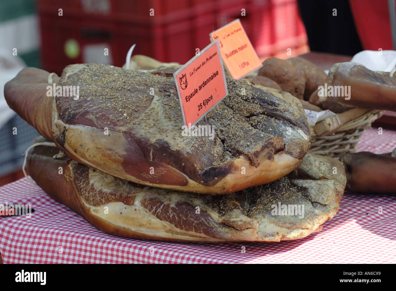 Two shoulders of Ardennes ham one on top of the other on a market stall in the Province of Luxembourg in South Belgium Stock Photo