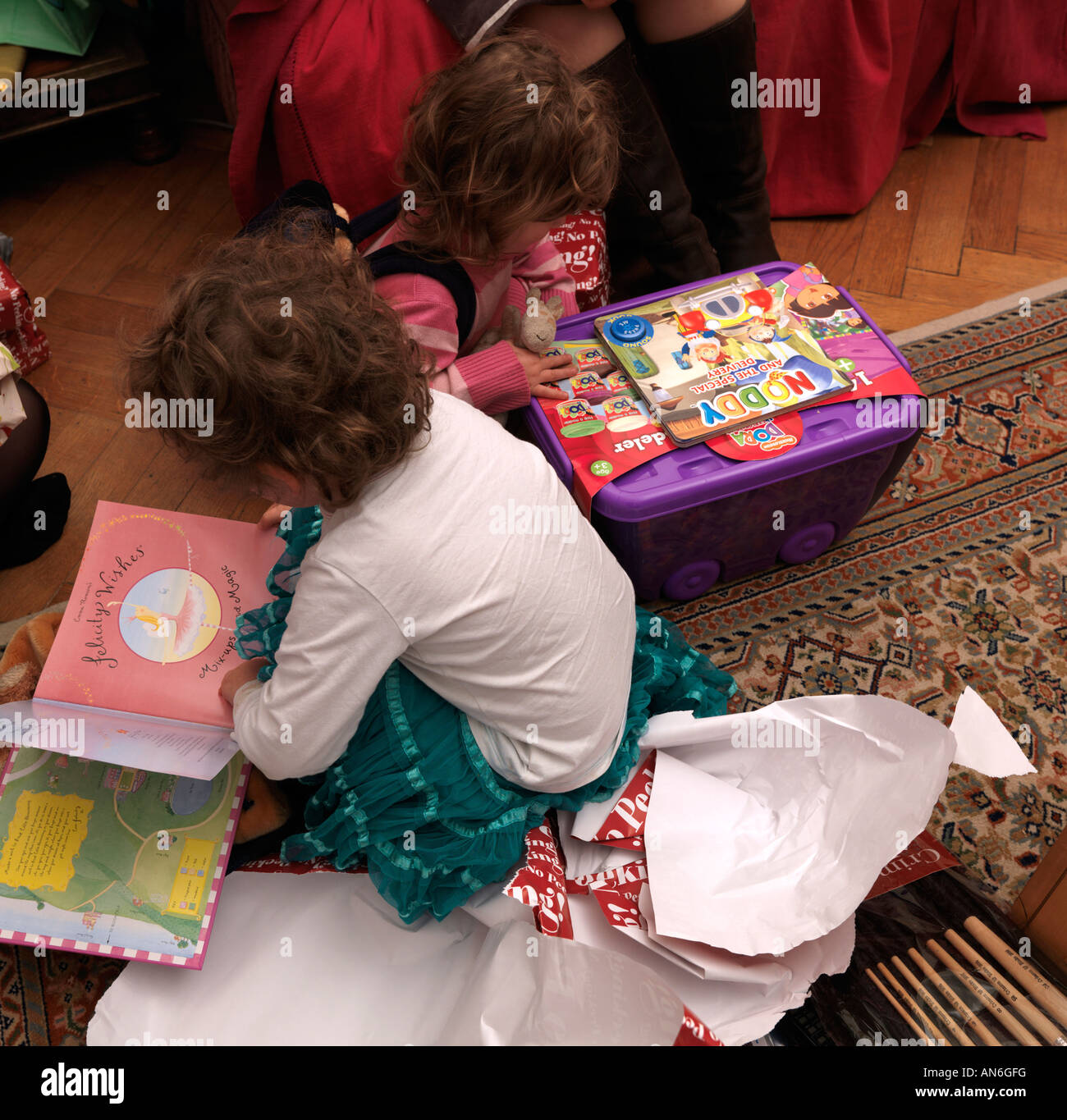 Little Girls Opening Presents on Christmas Day Stock Photo