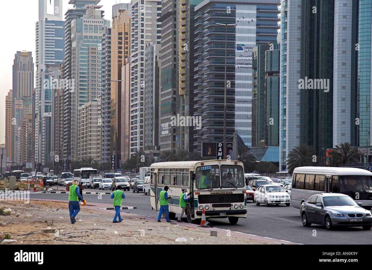 workers getting on bus on Sheikh Zayed Road on their way home Arbeiter steigen in den Bus und fahren nach Hause Dubai UAE Stock Photo