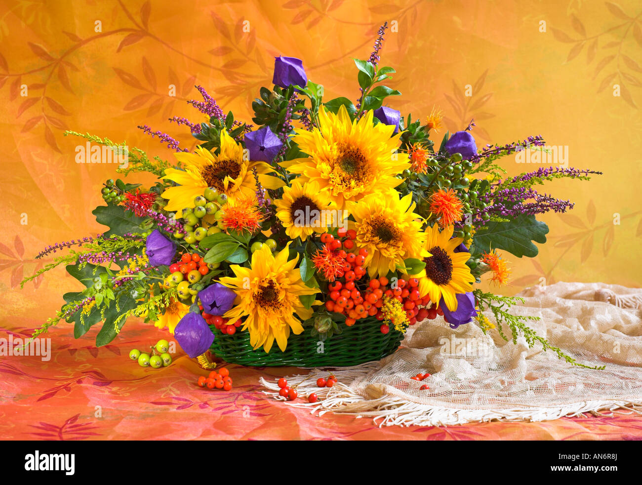 Studio arranged colorful bunch bouquet of yellow sunflowers in a basket ...