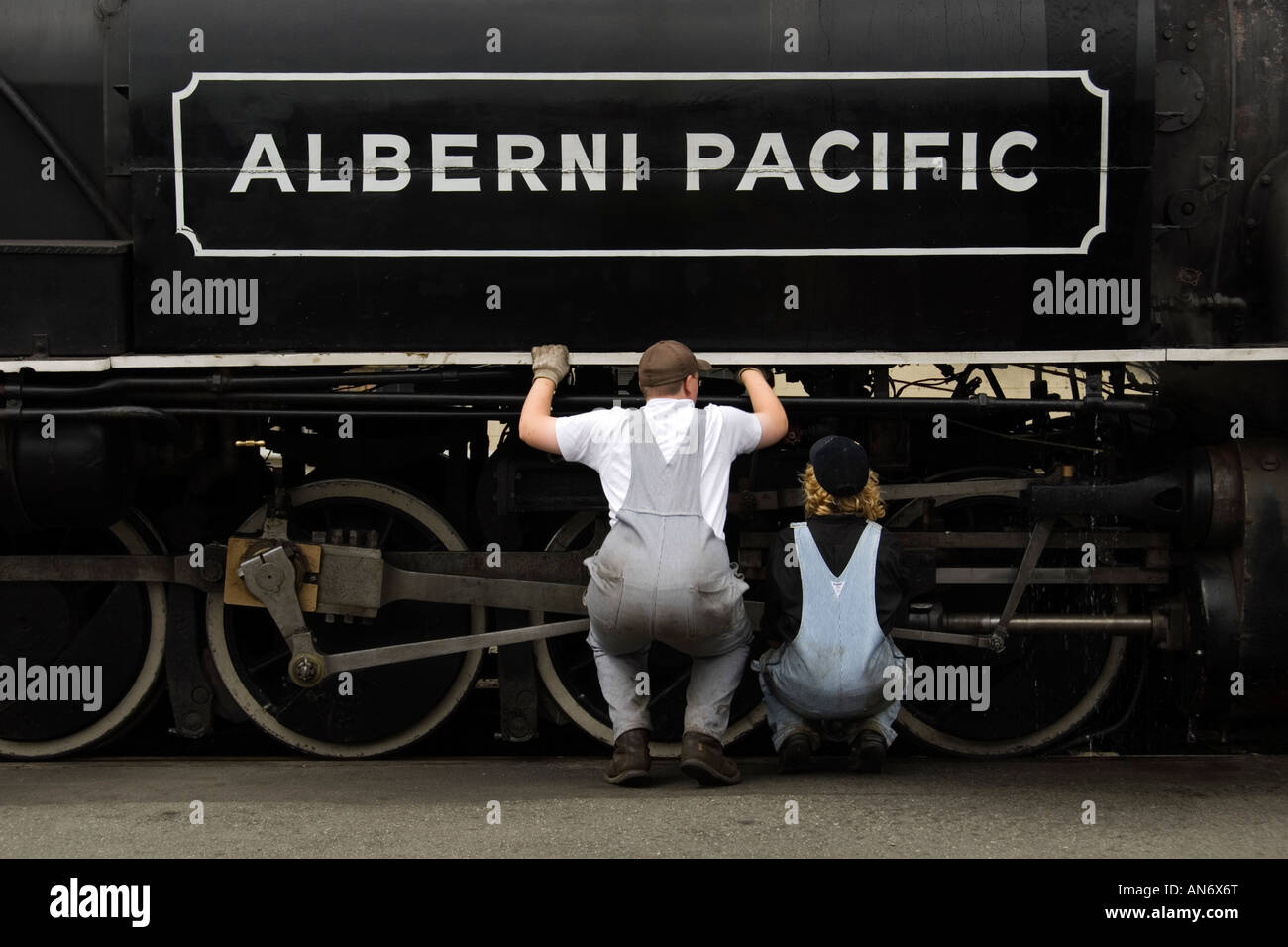 Engineers inspecting Alberni Pacific steam engine before a tourist excursion, Port Alberni, British Columbia, Canada Stock Photo