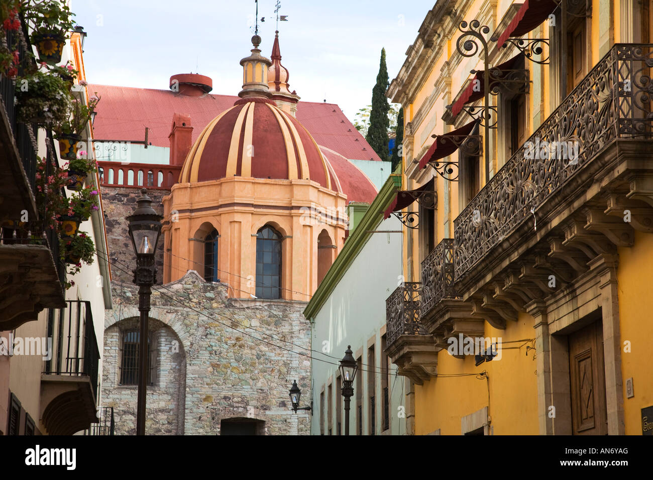MEXICO Guanajuato Dome of Templo de San Diego and iron railings on buildings along Alonso Street Stock Photo