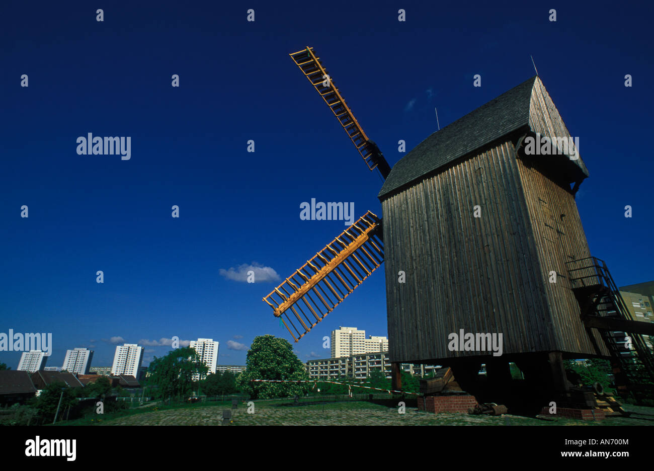 Berlin. Marzahn. Windmill on a hill in Alt-Marzahn with high-rise buildings of Marzahner Promenade in the background. Stock Photo