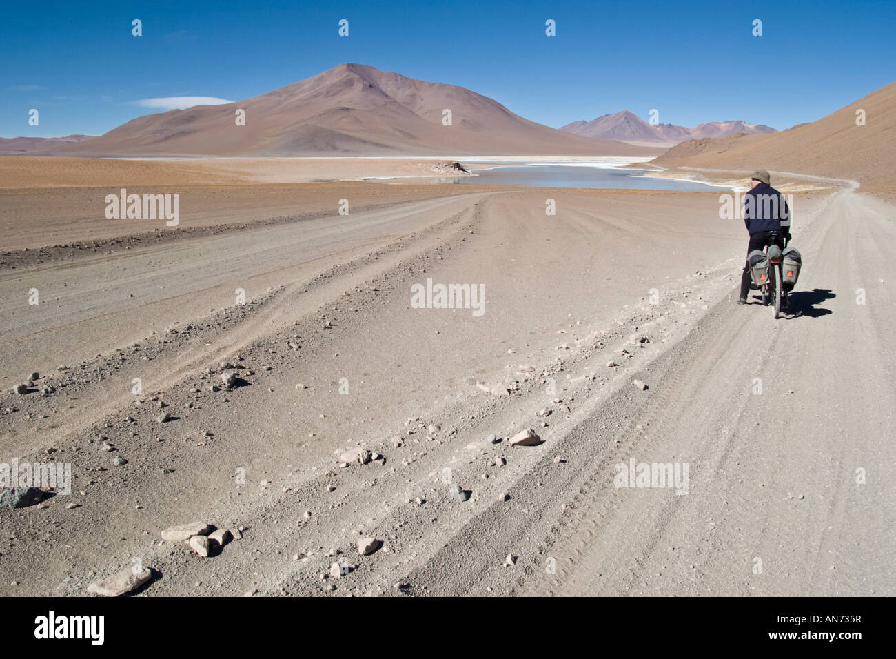 Cyclist on gravel road by Salar Chalviri, Boliva Stock Photo