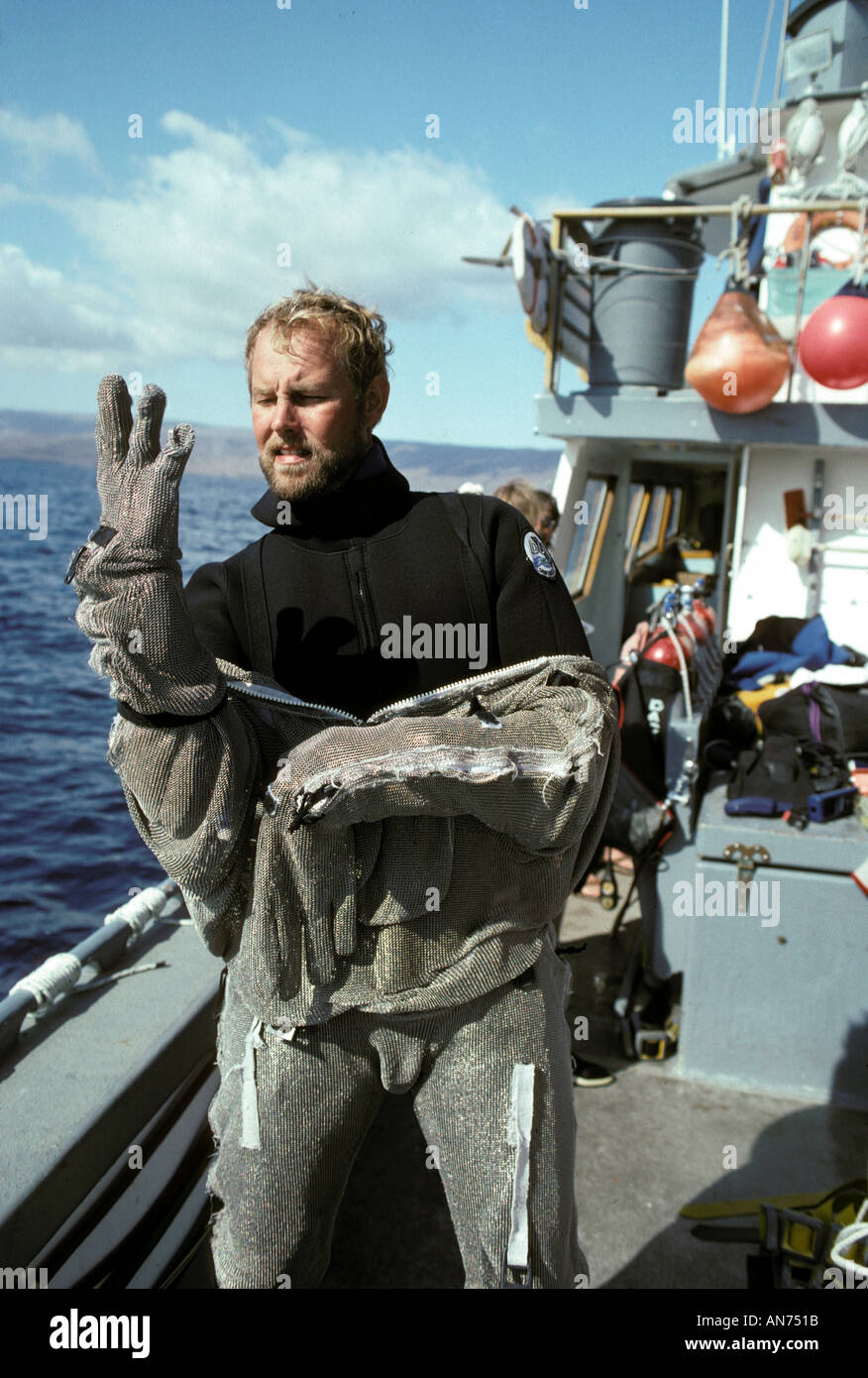 Bob Cranston dresses in chain mail suit to dive with Blue Sharks Stock