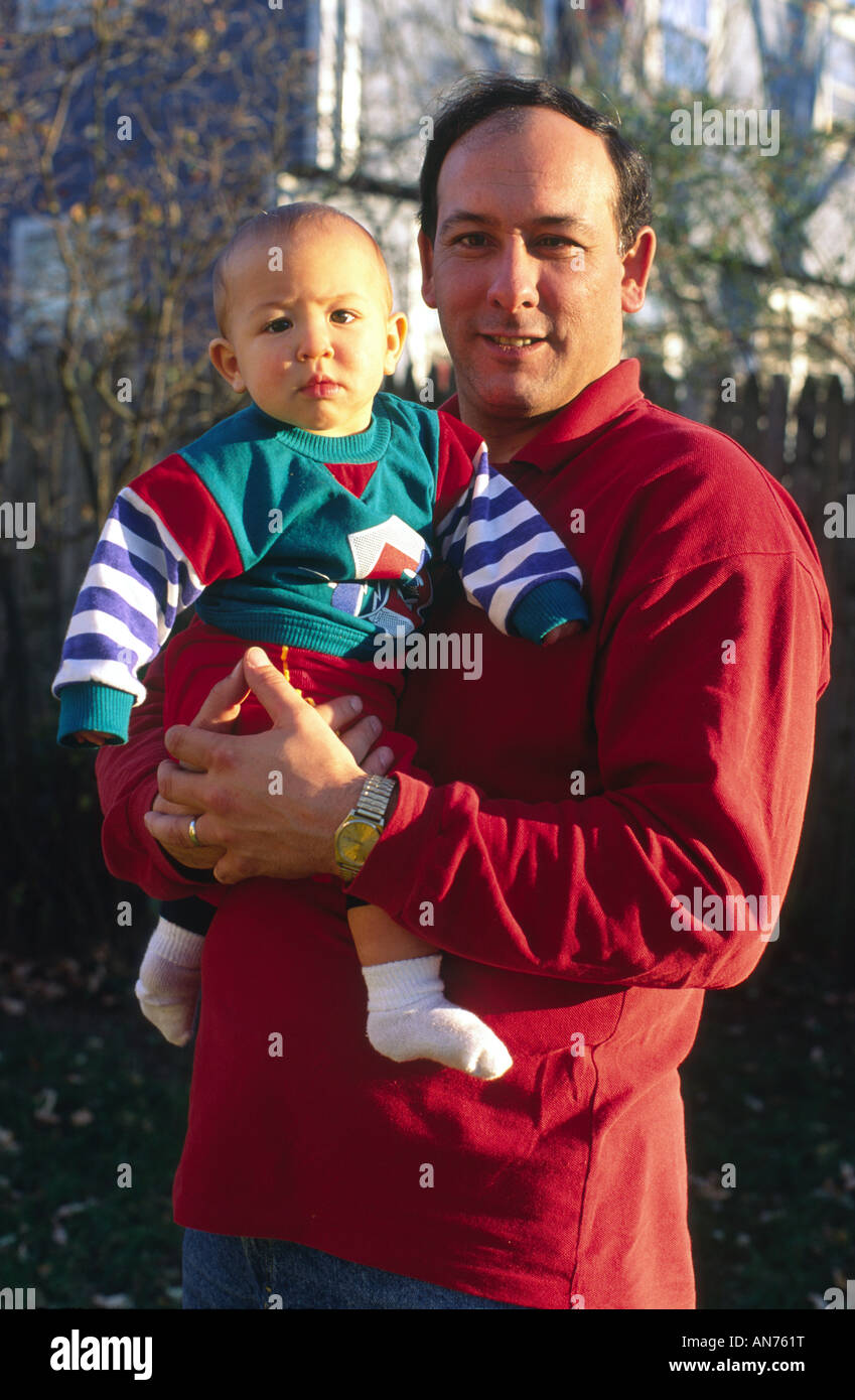 A father thirties holds his son Stock Photo
