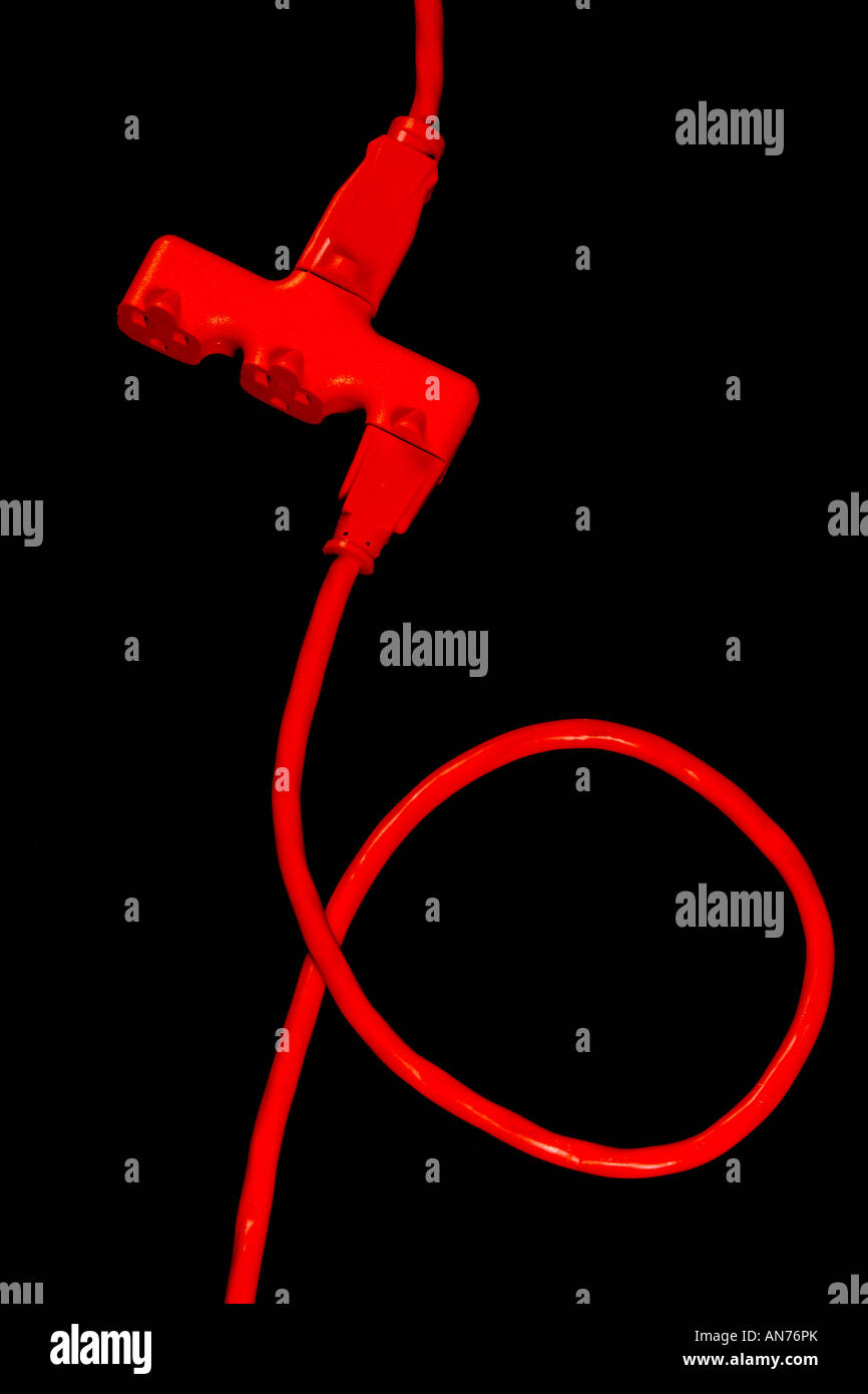 An orange extension cord connected to a three way splitter Stock Photo ...