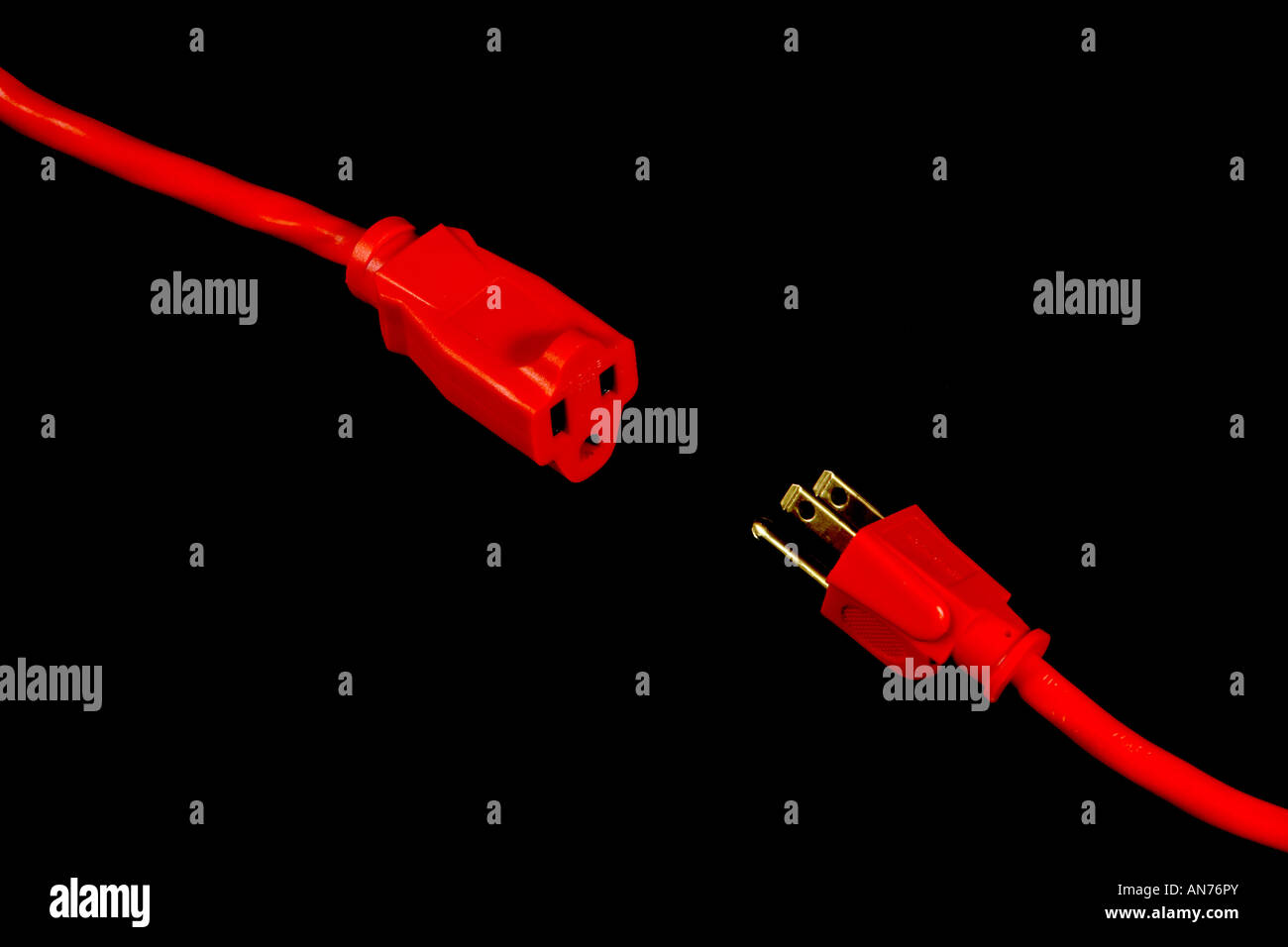 An orange extension cord connected to a three way splitter Stock Photo ...