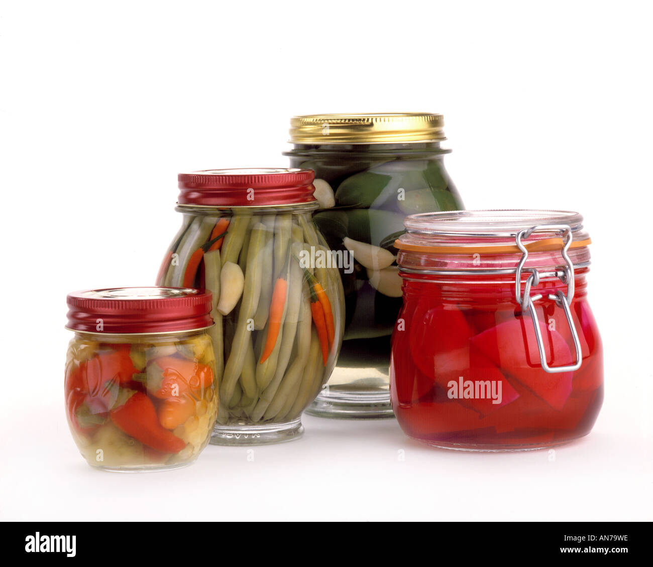 Jars of PICKLED PRODUCTS L TO R Serrano Peppers Green Beans Jalapenos Turnips Beets Stock Photo