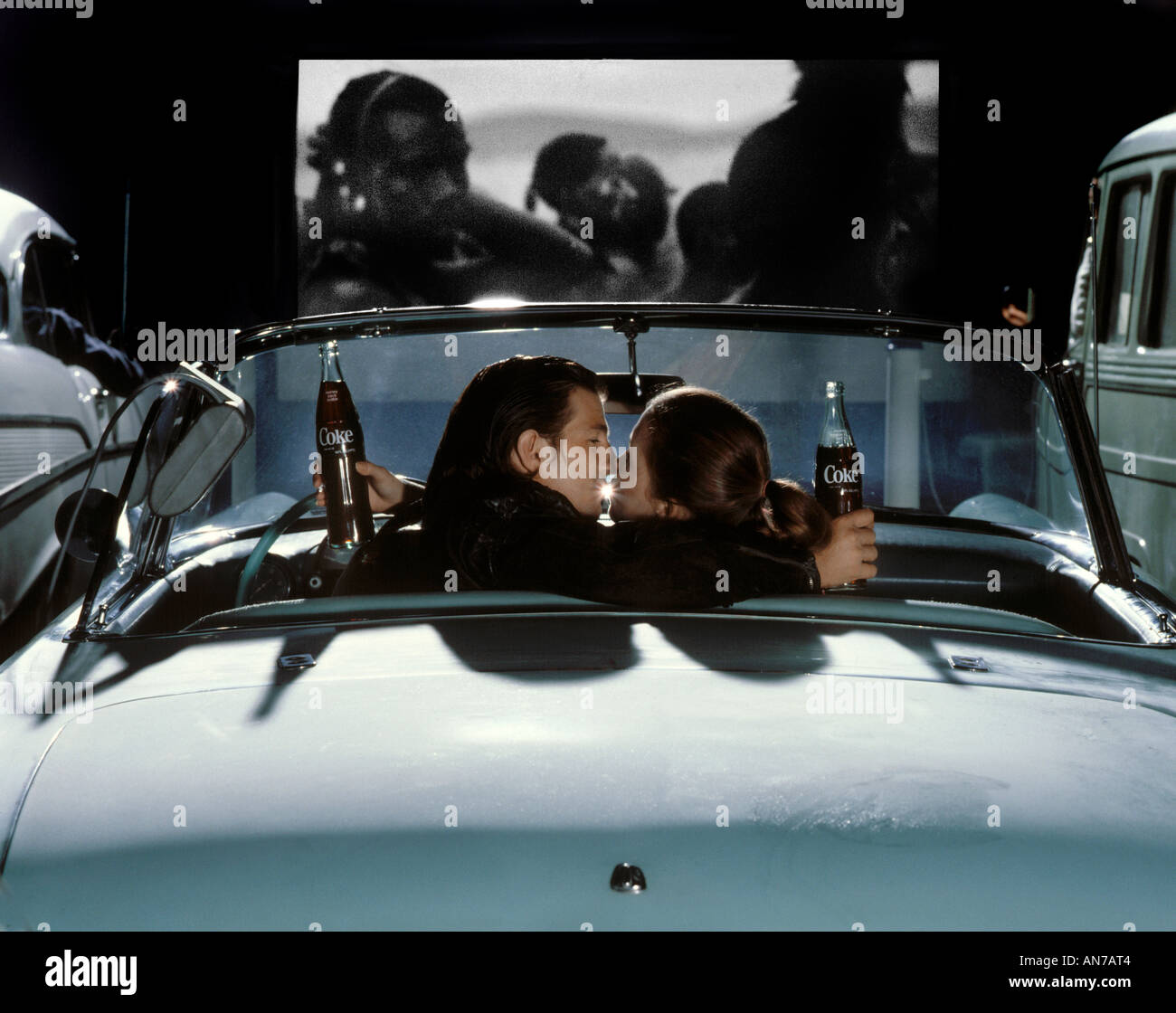 Young couple drinking cokes at the drive in MODEL RELEASED Stock Photo