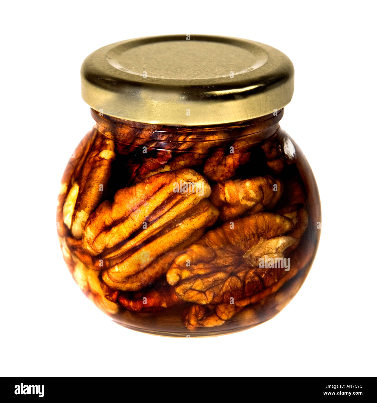Jar of pecan nuts in honey Stock Photo