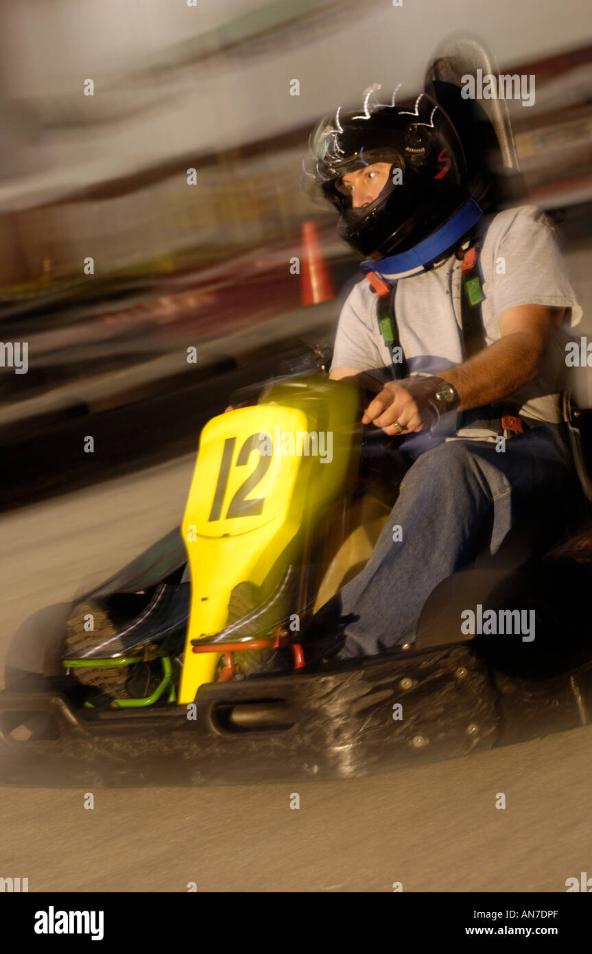 man driving a go kart at an indoor karting facility Stock Photo Alamy