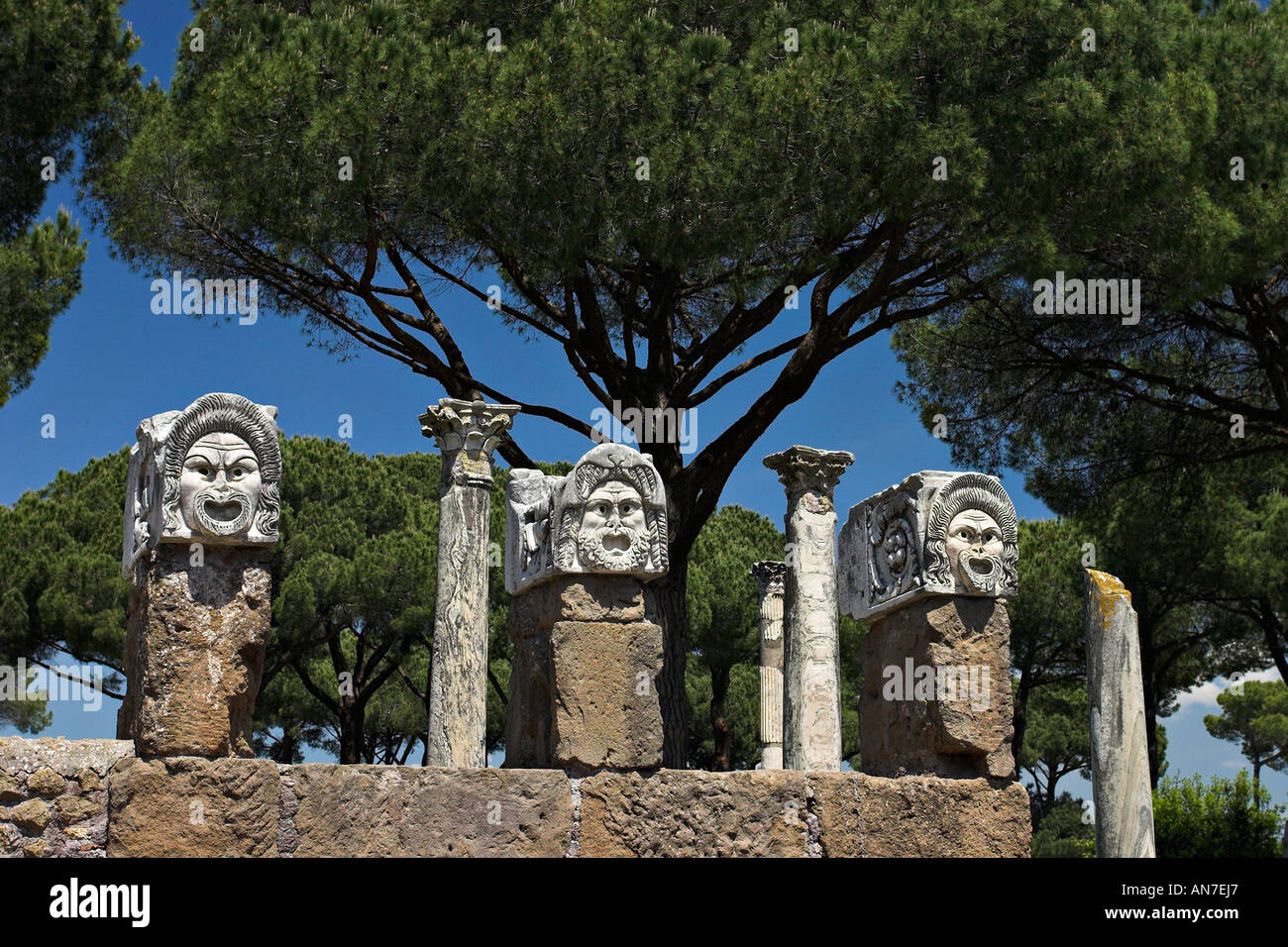 Stone Masks Three carved stone masks set on columns decorate and advertise the theatre Stock Photo