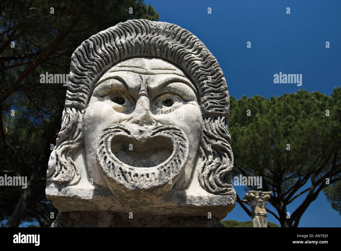 Carved stone mask that decorated and now advertise the ancient Greek theatre theater Stock Photo