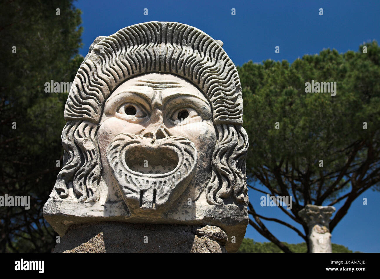 Carved stone mask that decorated and now advertise the ancient Greek theatre theater Stock Photo