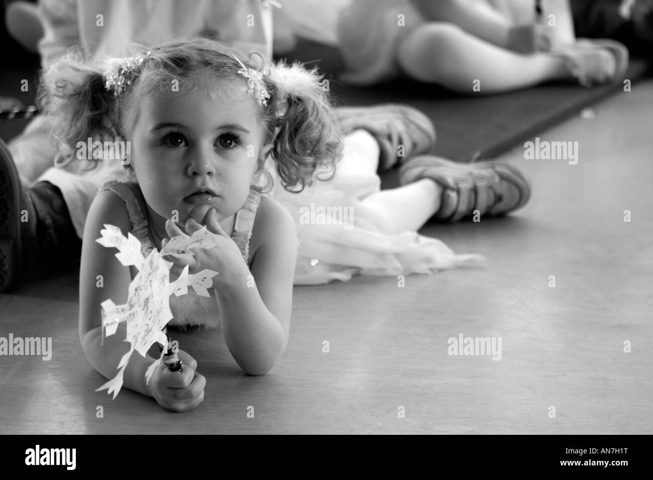 Thoughtful girl playing a snowflake in a Christmas play Stock Photo