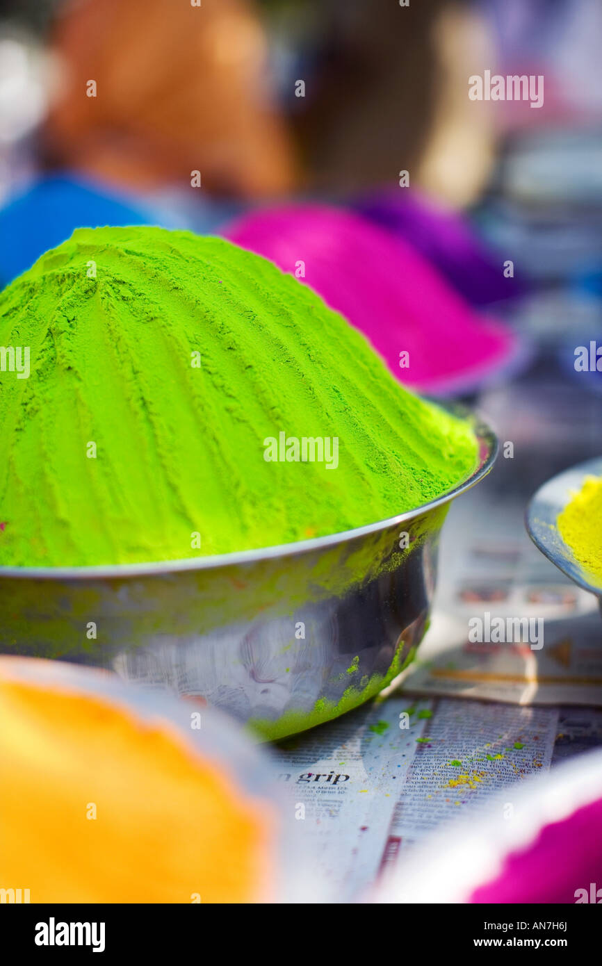 Metal bowls full of indian coloured rangoli powder. Puttaparthi, Andhra