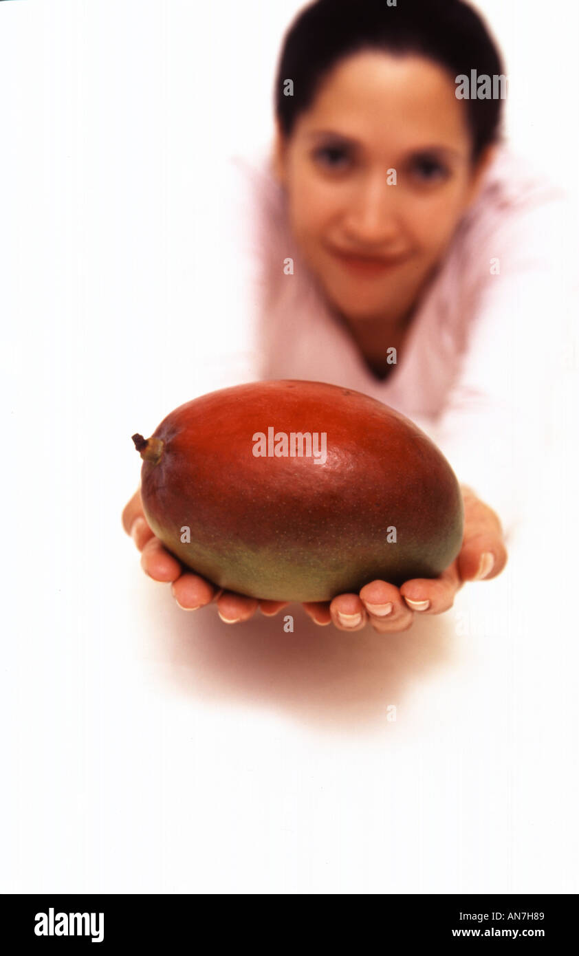 Portrait of a Hispanic female holding a mango fruit Stock Photo Alamy