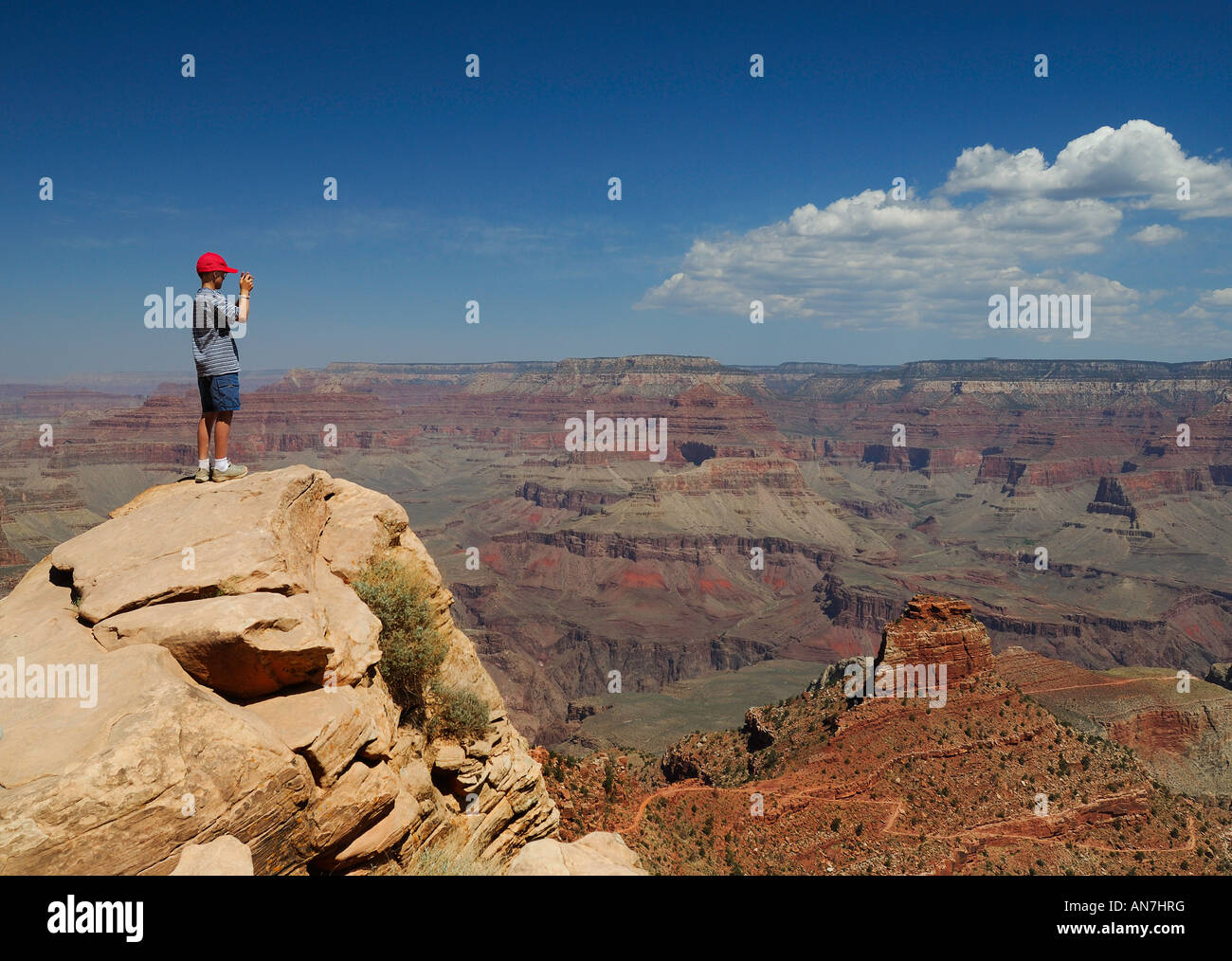 Boy taking landscape picture at Grand Canyon ooh-aah point hiking trail. Stock Photo