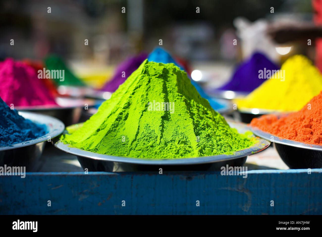 Metal bowls full of indian coloured rangoli powder. Puttaparthi, Andhra