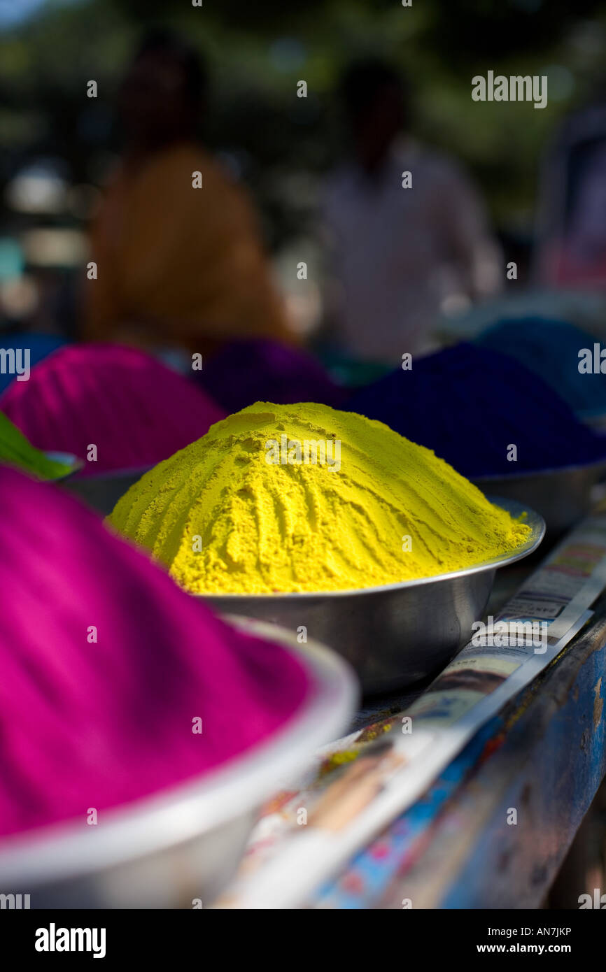 Metal bowls full of indian coloured rangoli powder. Puttaparthi, Andhra
