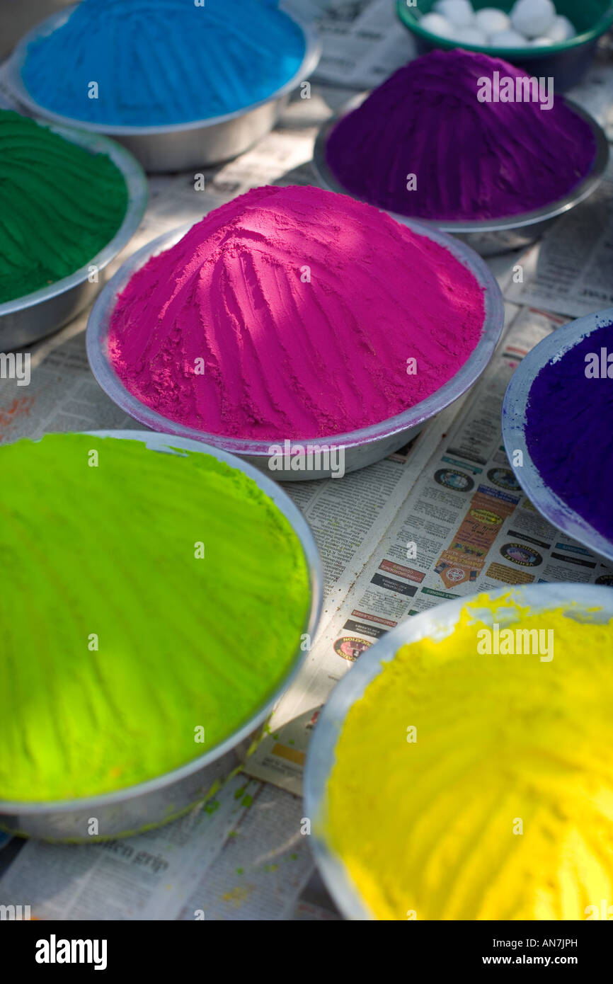 Metal bowls full of indian coloured rangoli powder. Puttaparthi, Andhra