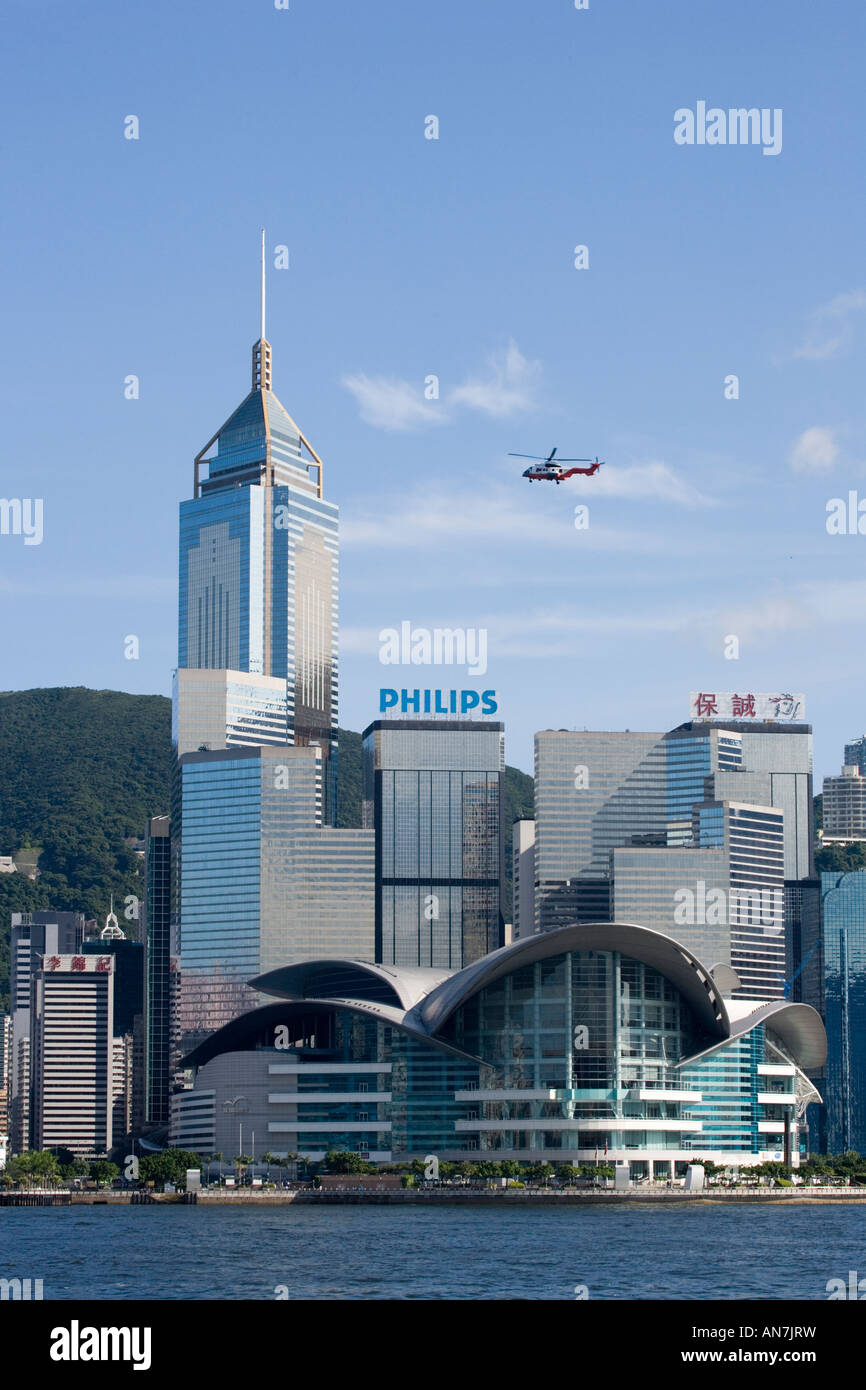 Helicopter flying over Wanchai and the Hong Kong International Convention and Exhibition Centre Hong Kong Island China Stock Photo