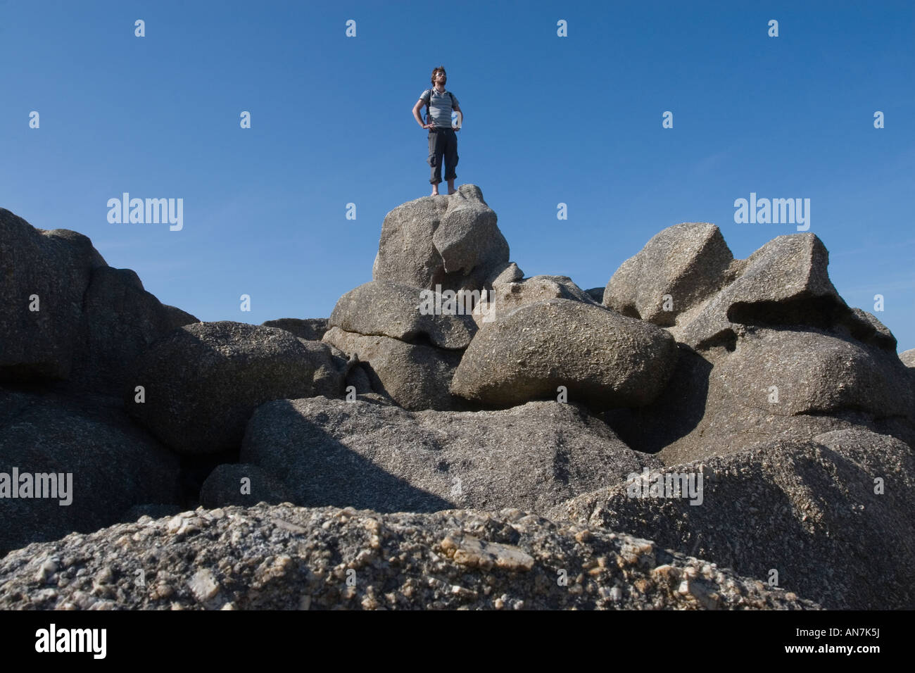 Man Standing on Rock Stock Photo