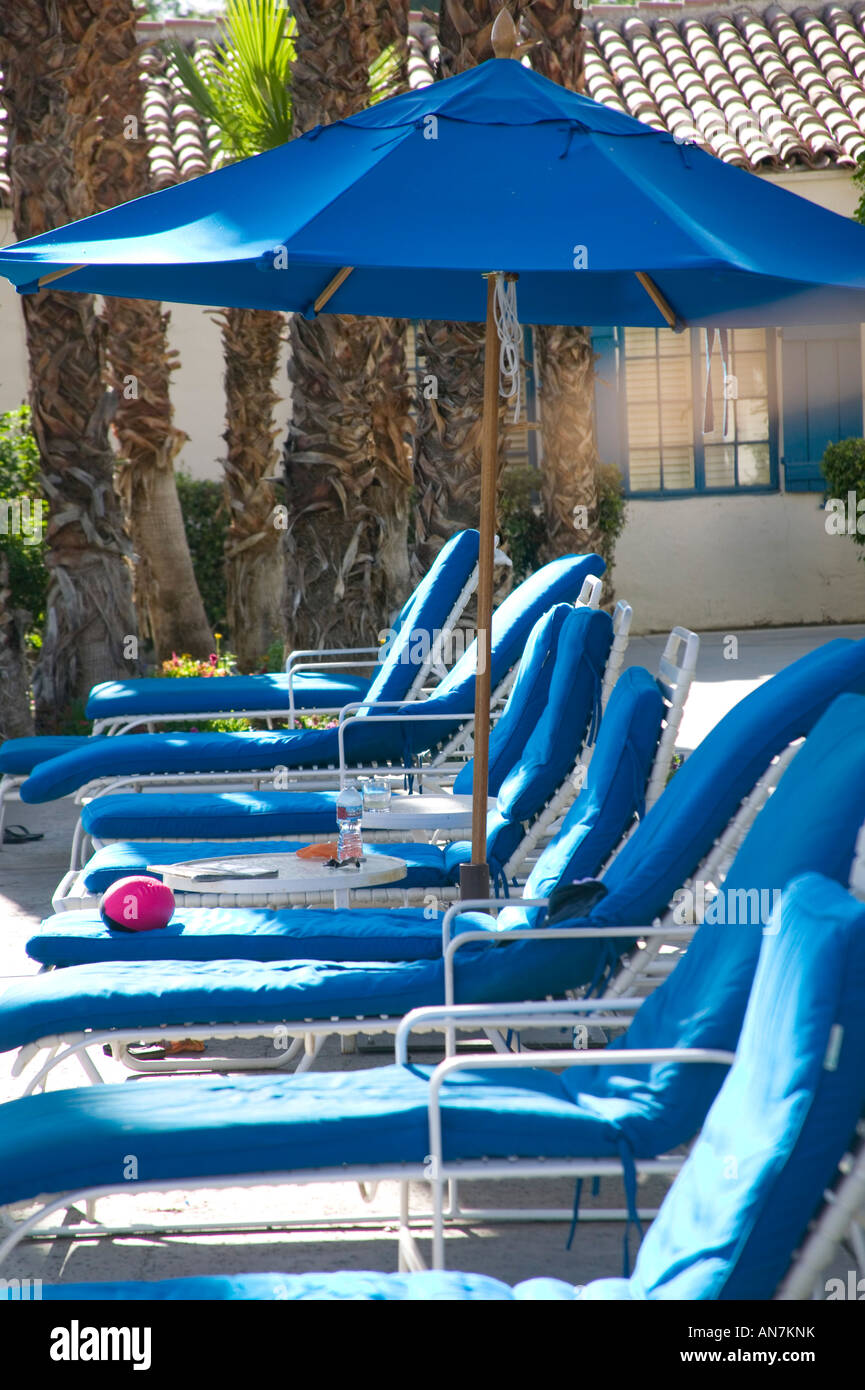 pool side blue lounge chairs in a row Stock Photo