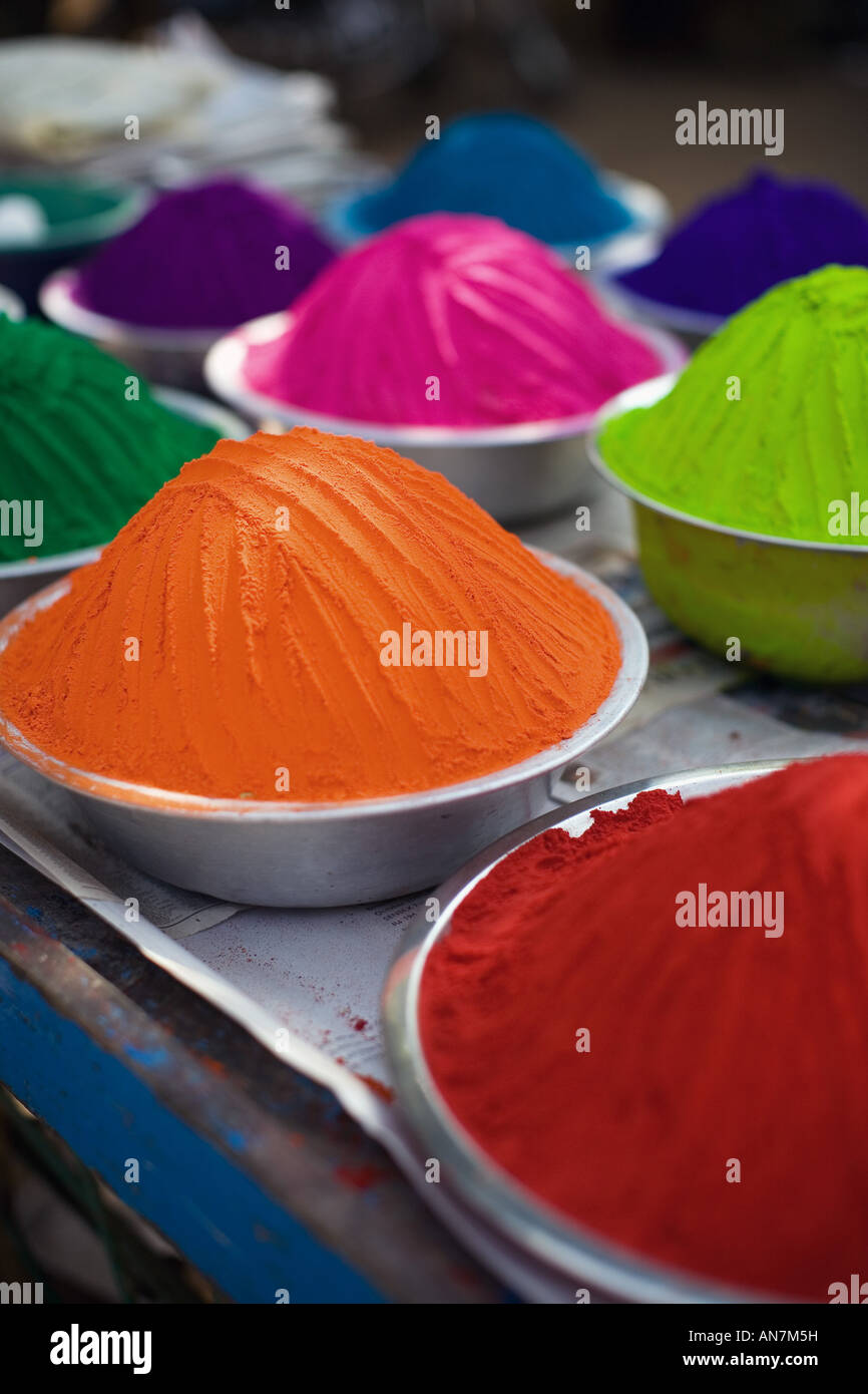Metal bowls full of indian coloured rangoli powder. Puttaparthi, Andhra