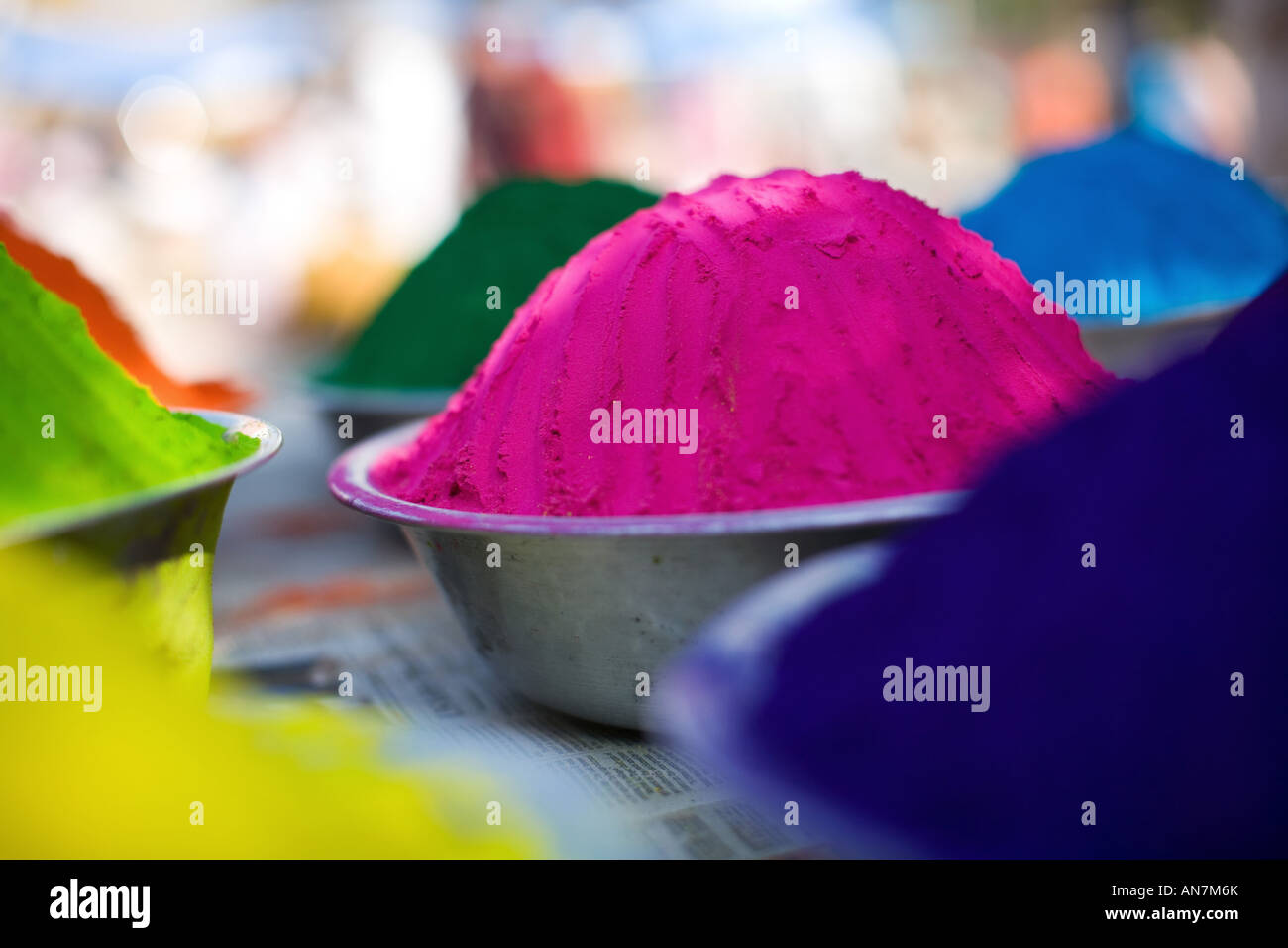 Metal bowls full of indian coloured rangoli powder. Puttaparthi, Andhra