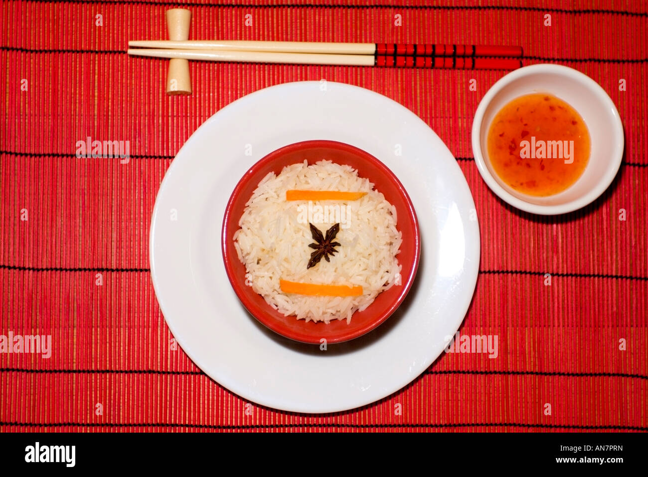Chinese rice meal bowl on a red bamboo matting pace setting with