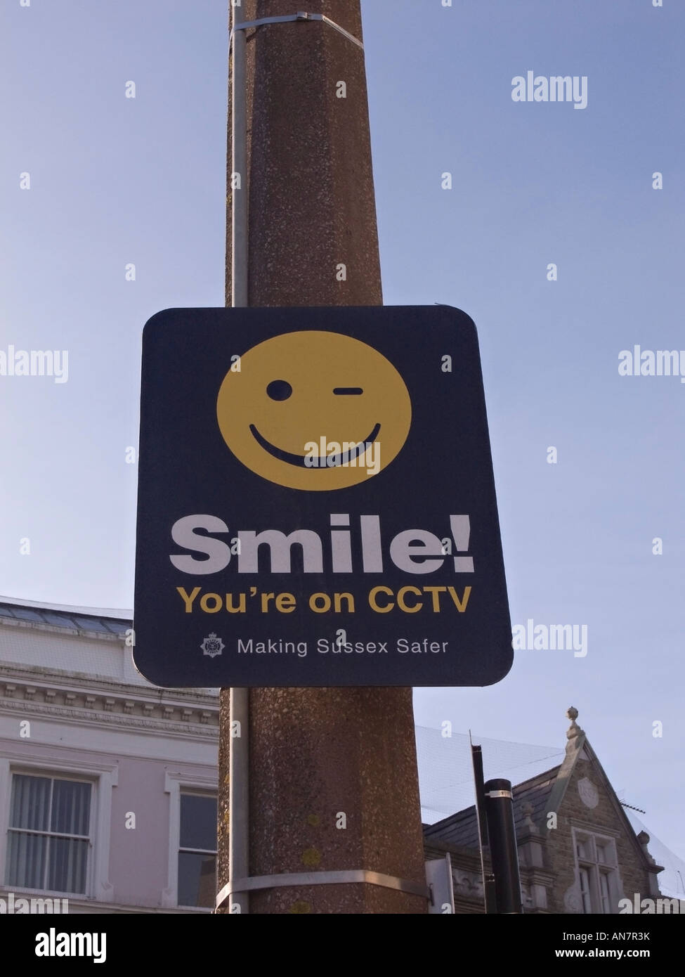 CCTV sign 'Smile you're on CCTV' fixed to a lamppost in Worthing, West Sussex, UK Stock Photo
