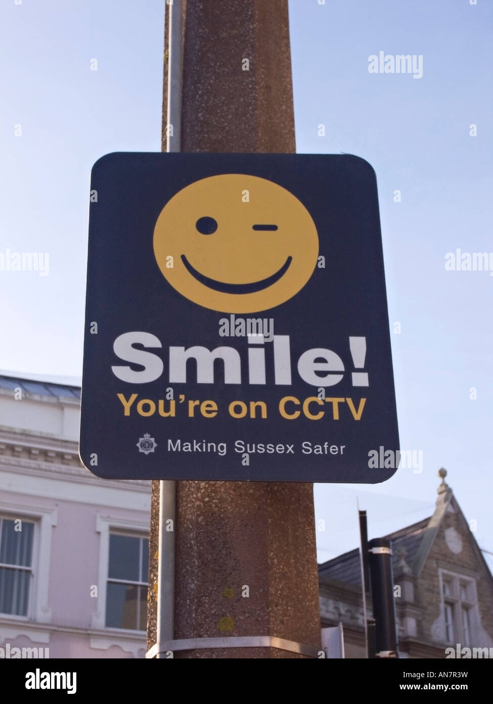 CCTV sign 'Smile you're on CCTV' fixed to a lamppost in Worthing, West Sussex, UK Stock Photo