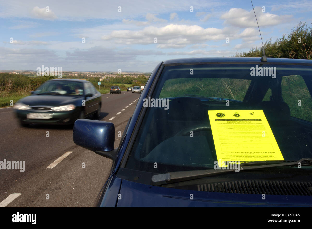 An abandoned car with a Police aware notice attached Stock Photo