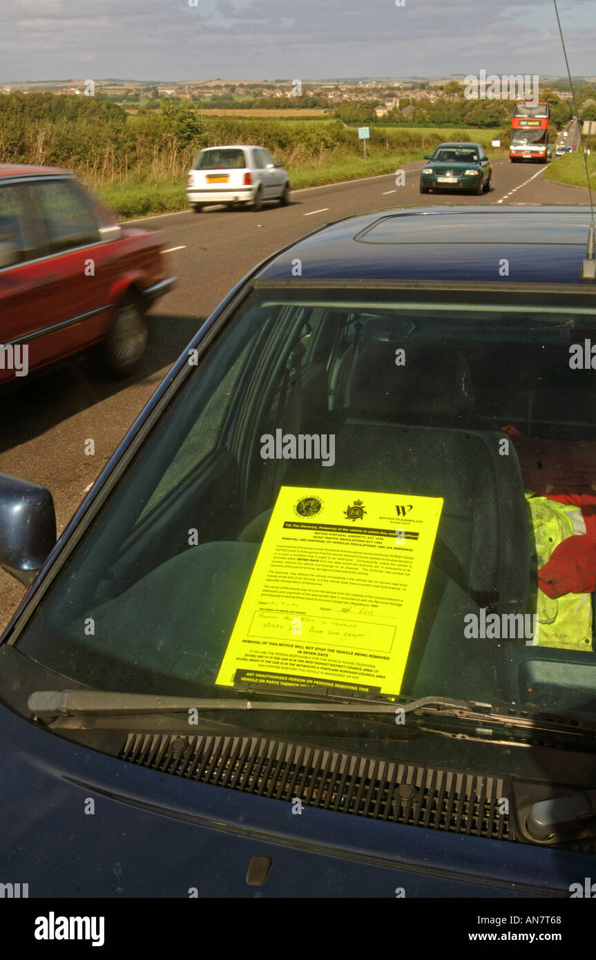 An abandoned car with a Police aware notice attached Stock Photo