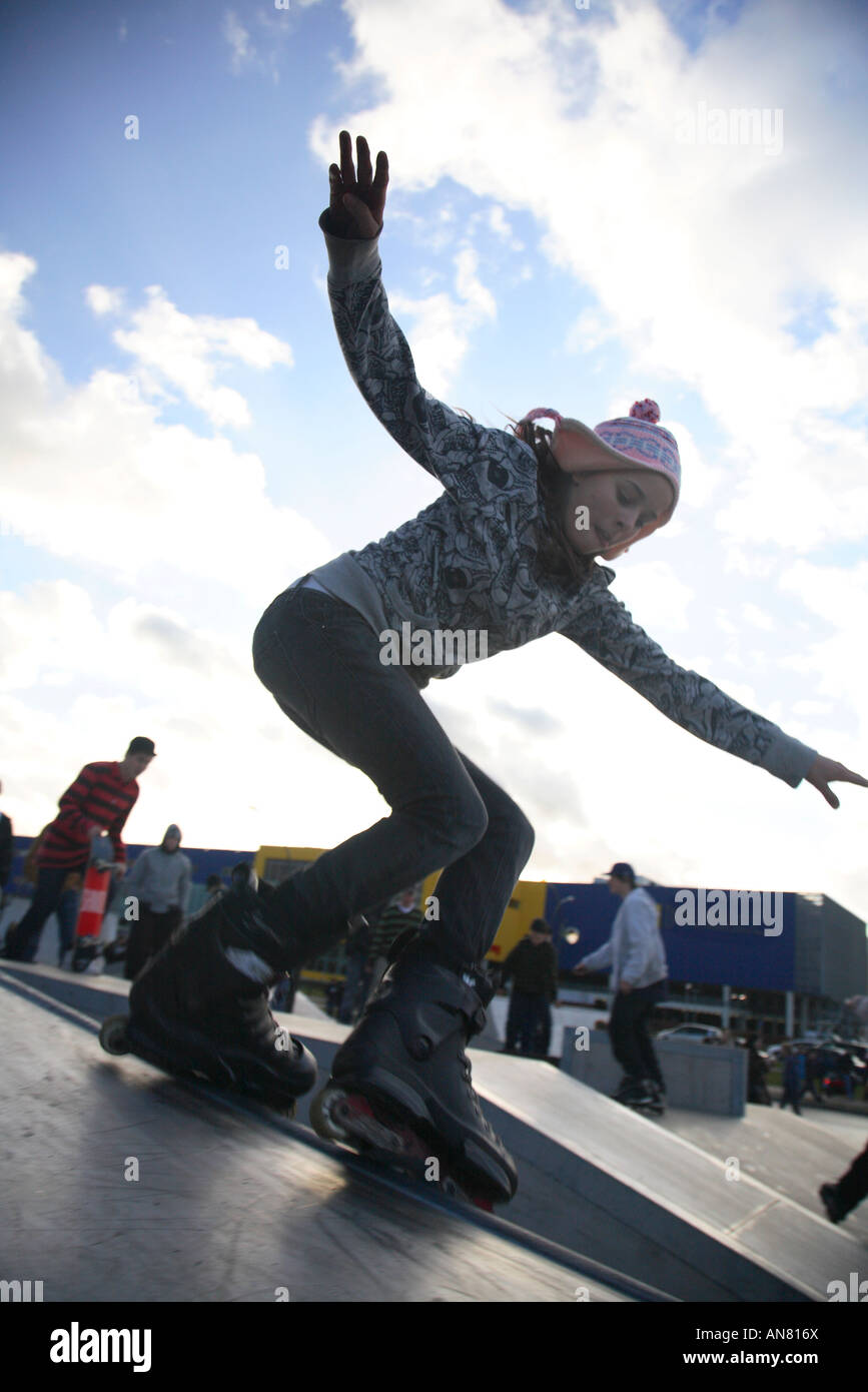 inline skater with inline skates doing tricks at skatepark Stock Photo