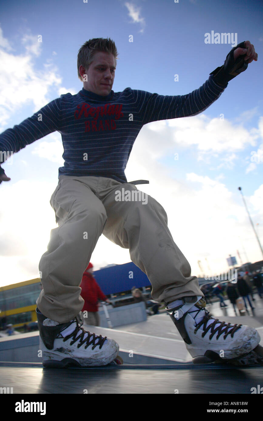 inline skater with inline skates doing tricks at skatepark Stock Photo