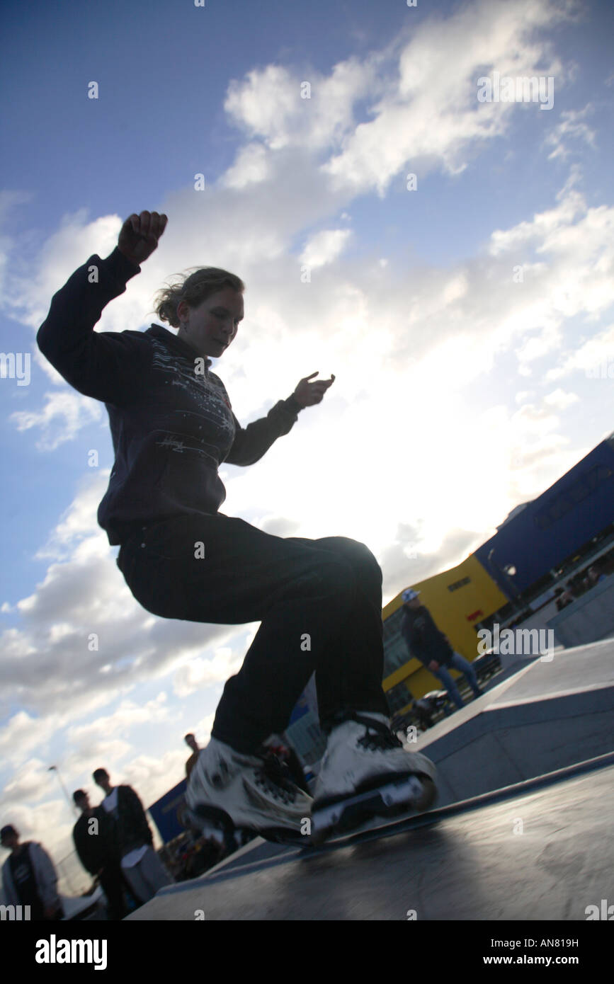 inline skater with inline skates doing tricks at skatepark Stock Photo